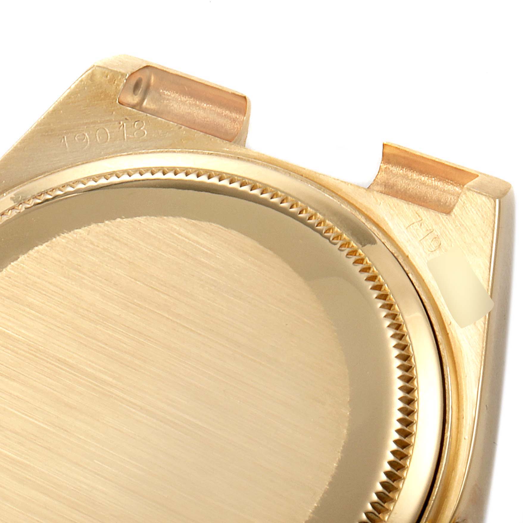 This image shows an angled close-up of the rear case of a Rolex President 19018 Men's Yellow Gold Champagne Dial 19018 Men's Yellow Gold Champagne Dial model watch.