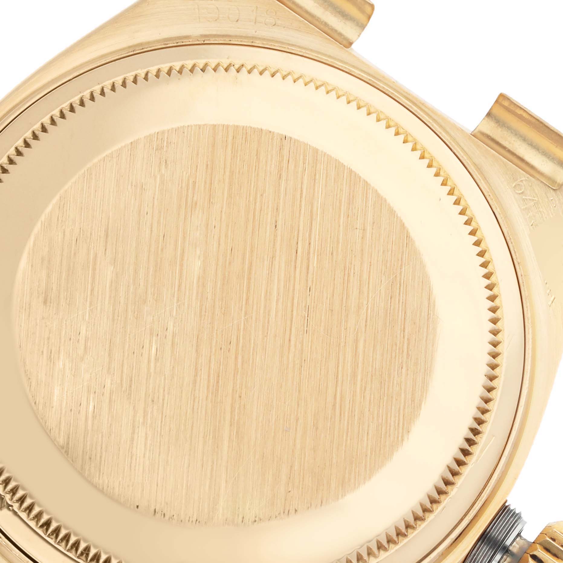 This is a close-up view of the back case of a Rolex President 19018 Men
s Yellow Gold Champagne Dial 19018 Men
s Yellow Gold Champagne Dial watch, focusing on the brushed finish and gold color.
