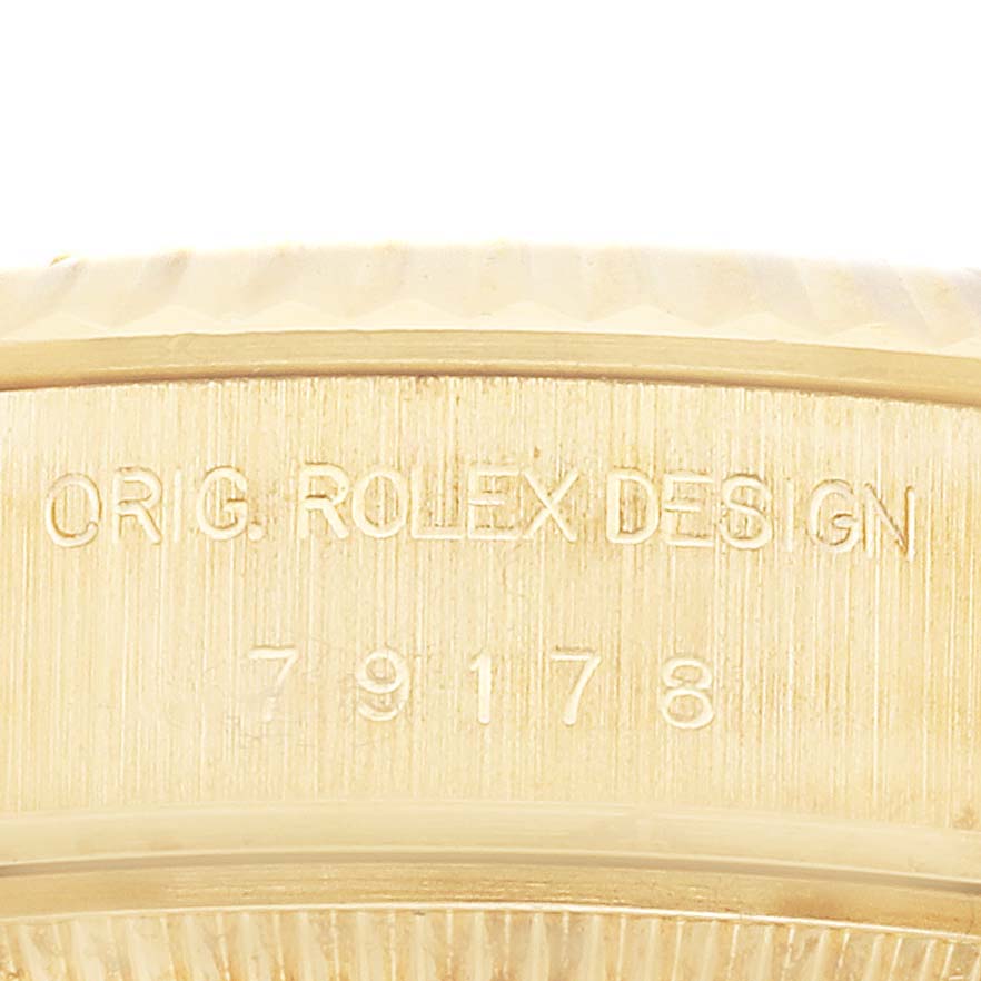 This close-up image shows the side engraving of the Rolex President 79178 Women
s Yellow Gold Champagne Dial 79178 Women
s Yellow Gold Champagne Dial model, featuring the text "ORIG. ROLEX DESIGN" and the model number.