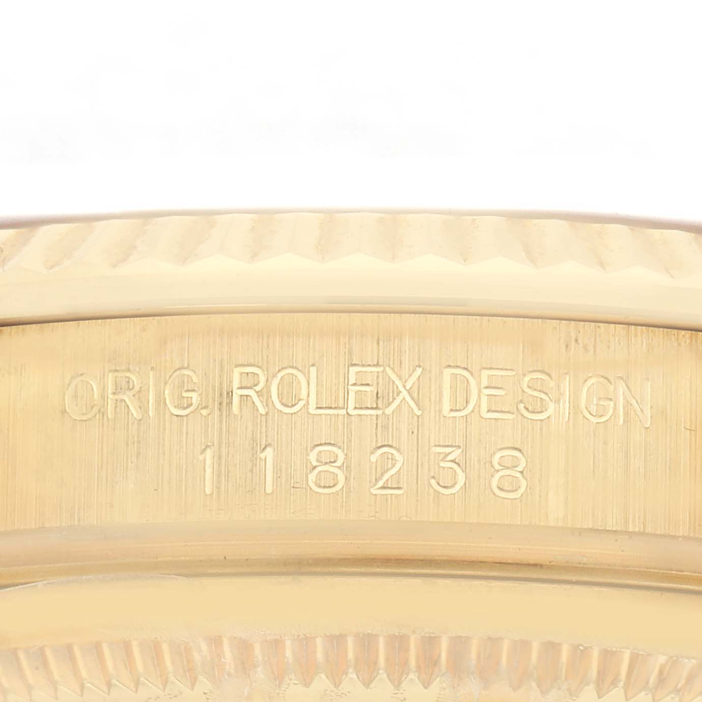 The image shows an angled close-up of the model and serial number engraving on the Rolex President 118238 Men
s Yellow Gold Champagne Dial 118238 Men
s Yellow Gold Champagne Dial
s case side.