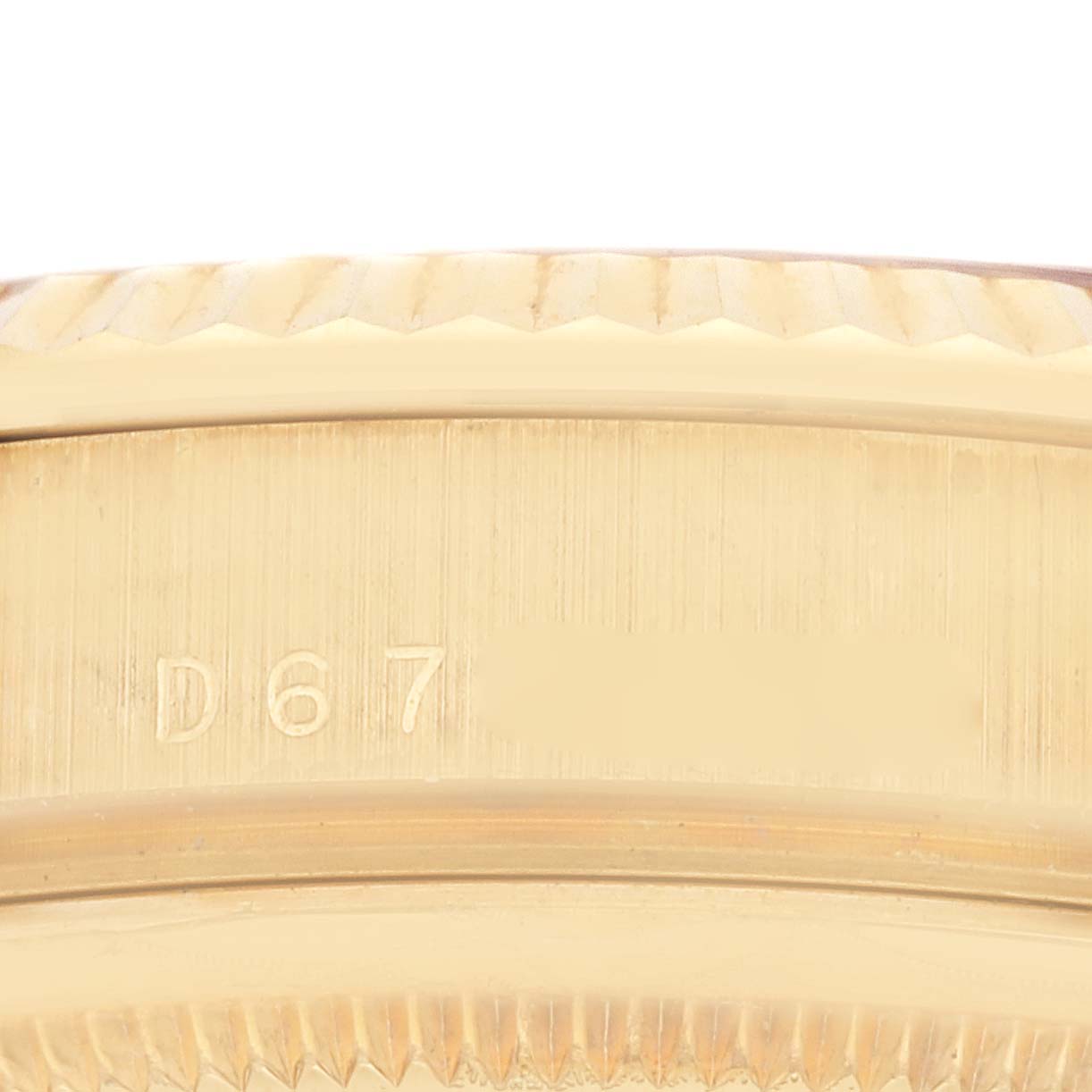 The image shows a close-up of the side of a Rolex President 118238 Men
s Yellow Gold Champagne Dial 118238 Men
s Yellow Gold Champagne Dial model watch, focusing on the engraved serial or model number.