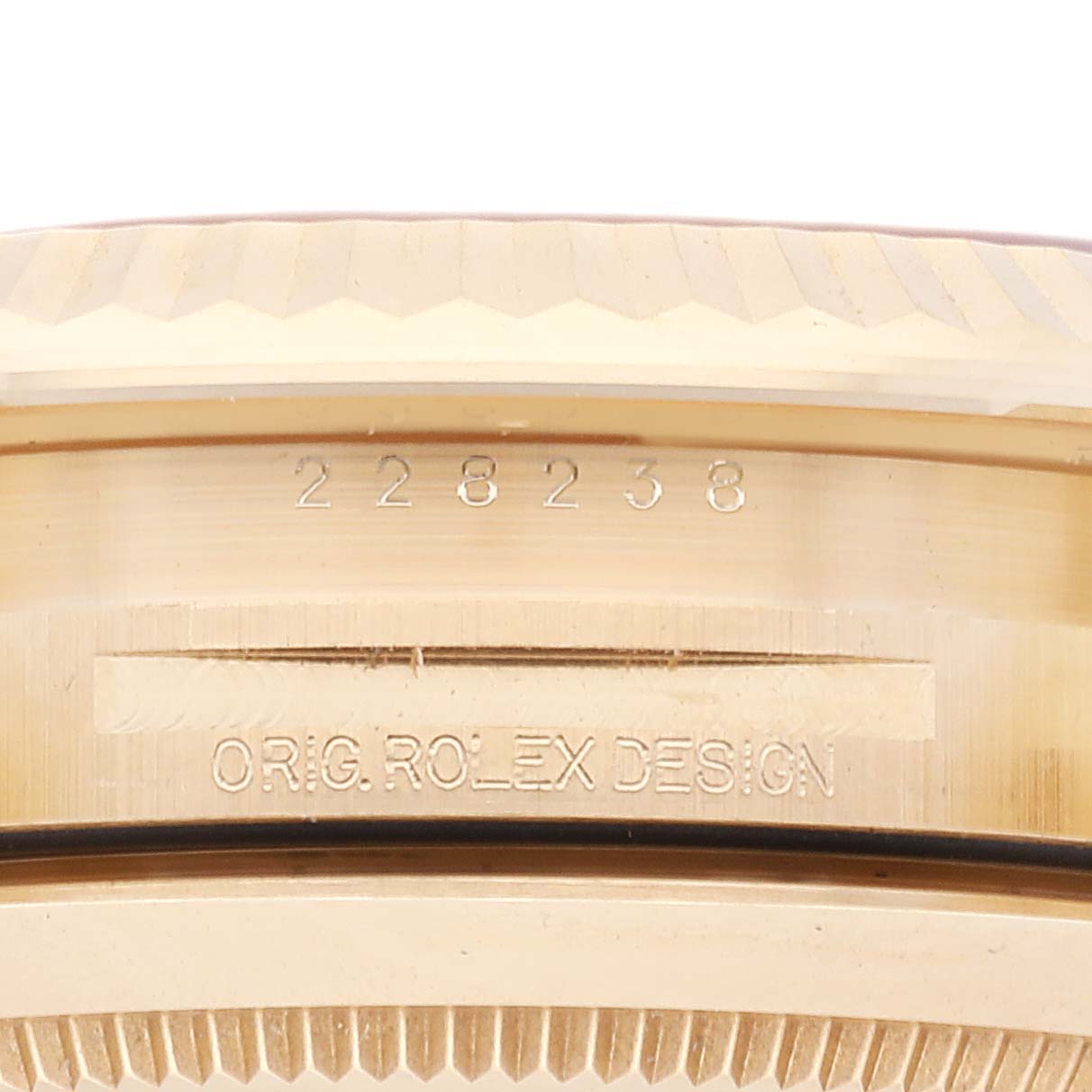 This close-up angle shows the side of the Rolex President 228238 Men's Yellow Gold Black Dial 228238 Men's Yellow Gold Black Dial watch, highlighting the model number and engraving.