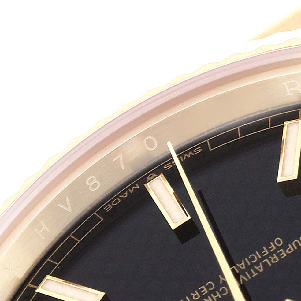 This is a close-up view of the dial and edge of the Rolex President 228238 Men's Yellow Gold Black Dial 228238 Men's Yellow Gold Black Dial model watch, showing the serial number and part of the hour markers.
