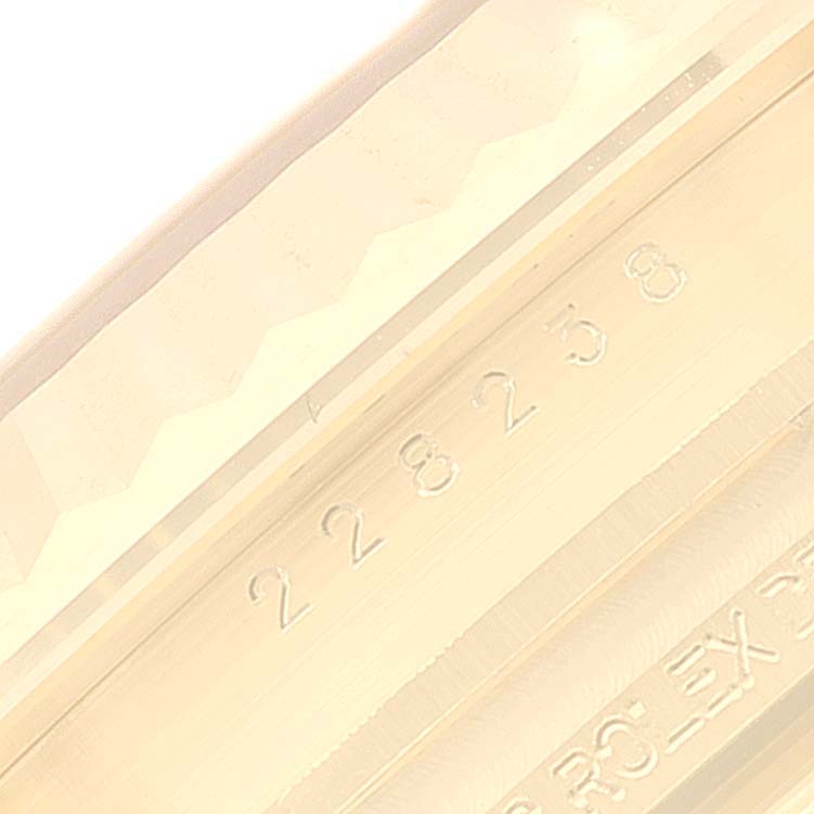 This image shows a close-up of the serial number and part of the bezel of a Rolex President 228238 Men's Yellow Gold Silver Dial 228238 Men's Yellow Gold Silver Dial model watch.