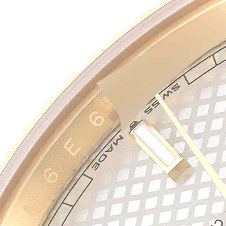 This close-up image shows a partial view of the dial and bezel of the Rolex President 228238 Men's Yellow Gold Silver Dial 228238 Men's Yellow Gold Silver Dial model watch.