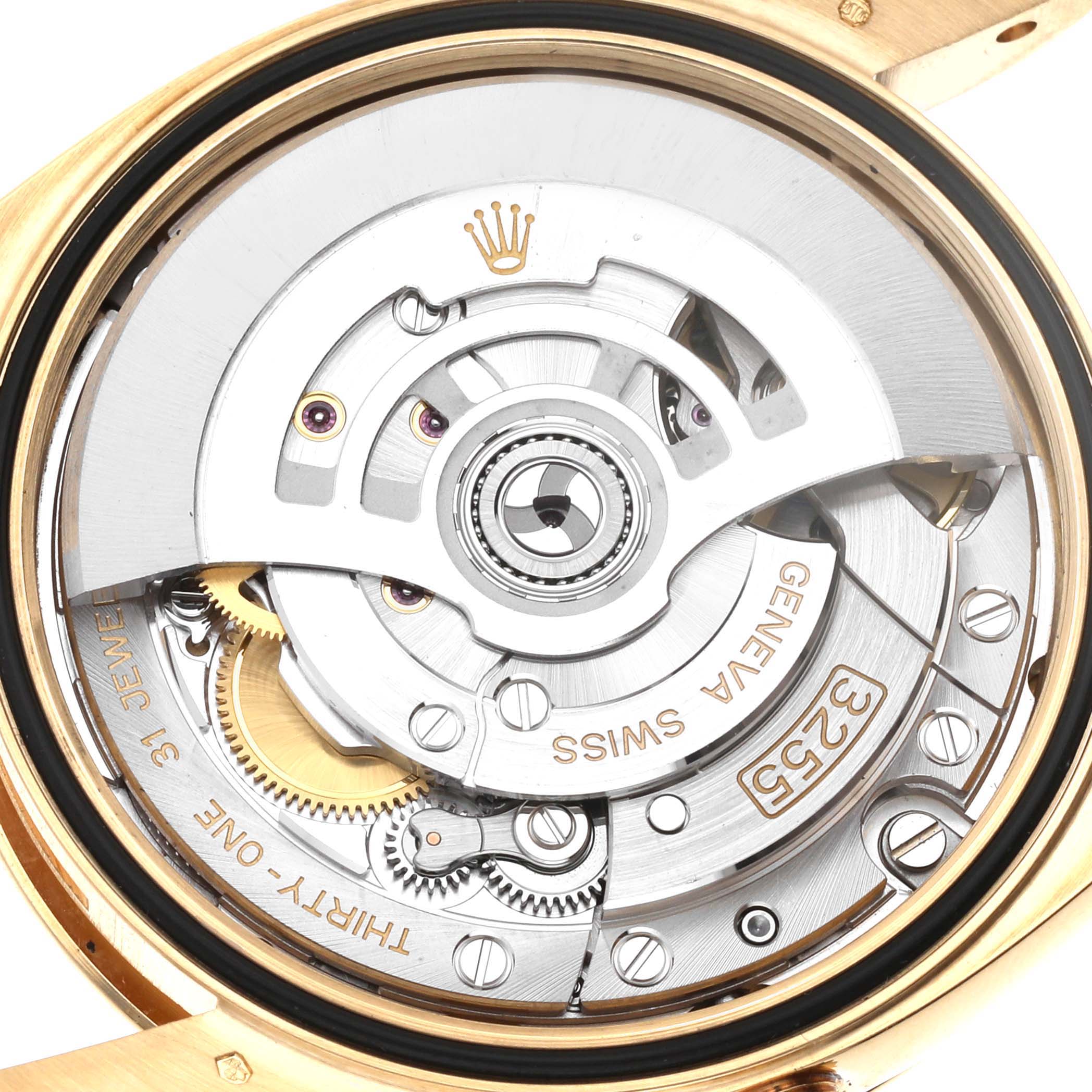 The image shows the internal mechanism of a Rolex President 128238 Men
s Yellow Gold Green Dial 128238 Men
s Yellow Gold Green Dial model watch from a back angle, highlighting gears and the rotor.