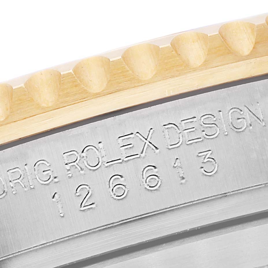 This close-up image shows the bezel and engraved model number of a Rolex Submariner 126613 Men's Steel and Gold (two tone) Blue Dial 126613 Men's Steel and Gold (two tone) Blue Dial watch.