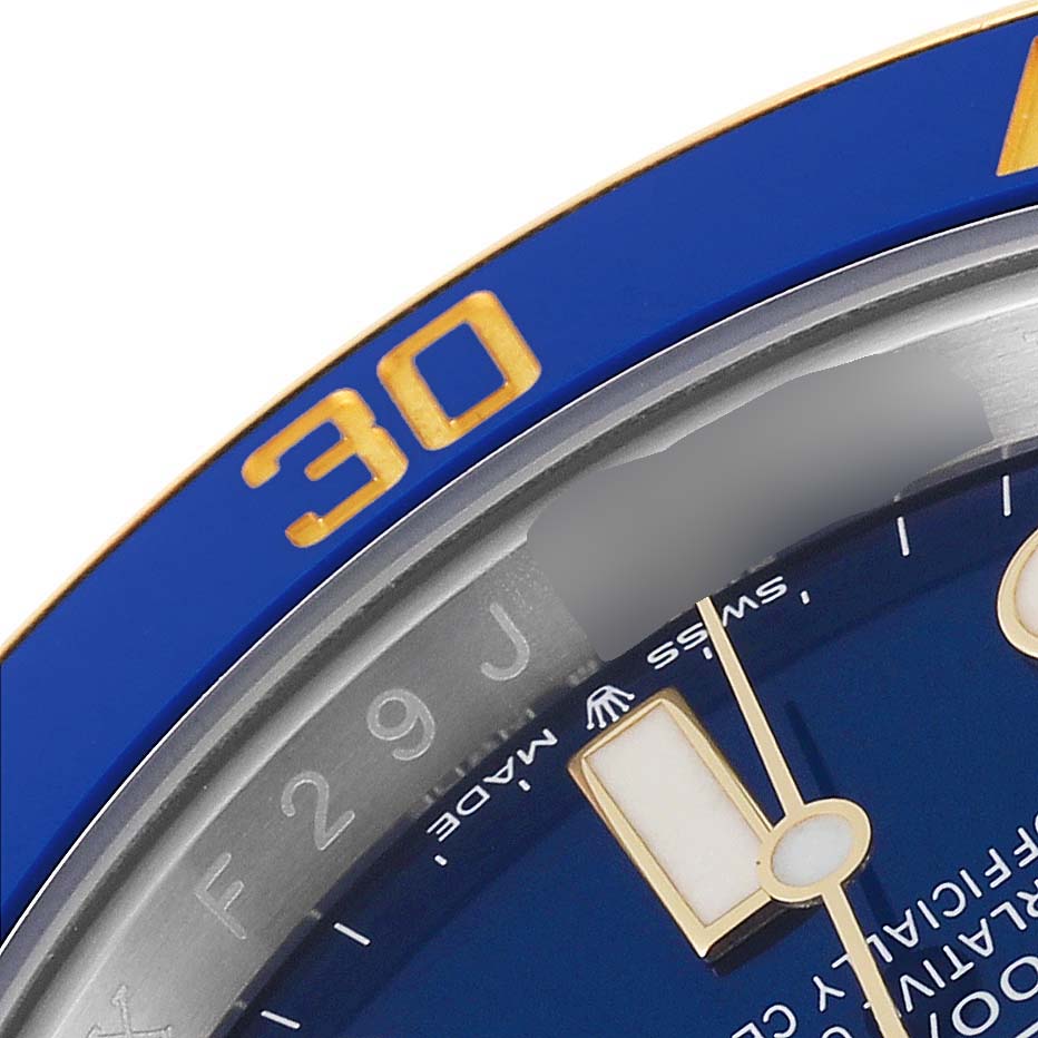 The image shows a close-up of the dial and bezel of a Rolex Submariner 126613 Men's Steel and Gold (two tone) Blue Dial 126613 Men's Steel and Gold (two tone) Blue Dial watch, highlighting the 30-minute marker and a partial view of the hands.