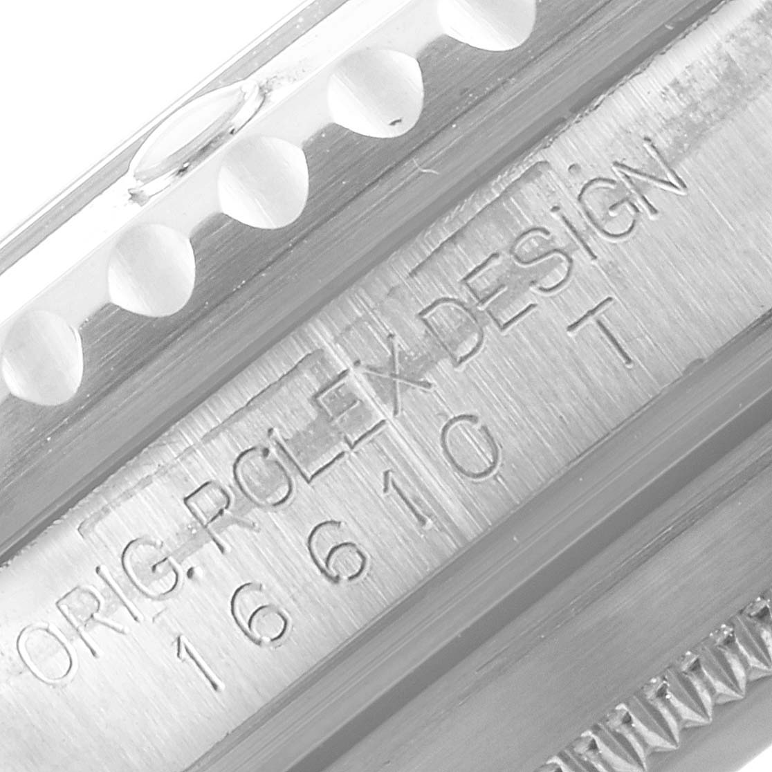 The image shows a close-up of the side with engravings and part of the bezel of a Rolex Submariner 16610 Men
s Stainless Steel Black Dial 16610 Men
s Stainless Steel Black Dial model watch.