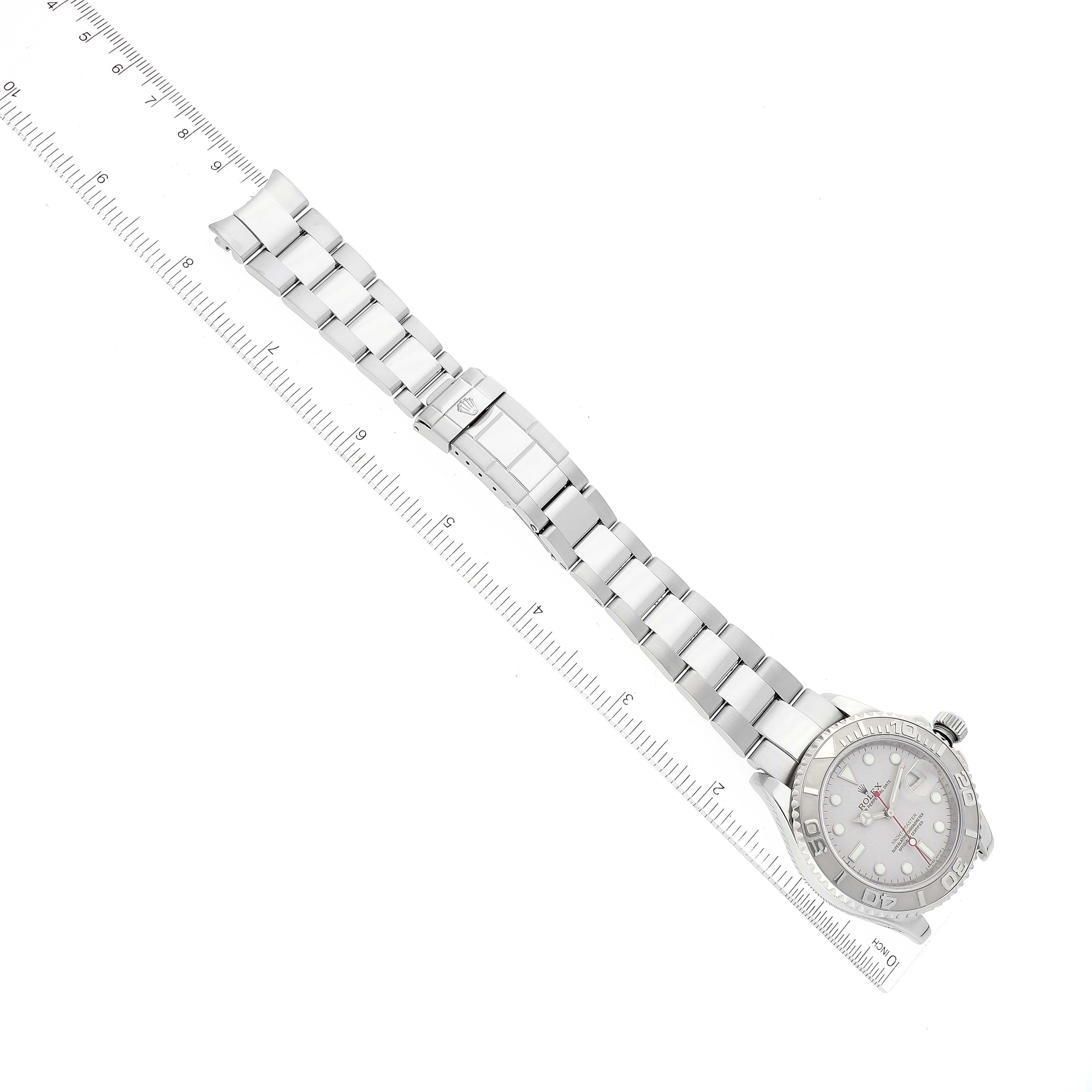 The image shows a top-down view of a Rolex Yacht-Master 16622 Men
s Stainless Steel Silver Dial 16622 Men
s Stainless Steel Silver Dial watch displaying the full bracelet and face alongside a ruler.