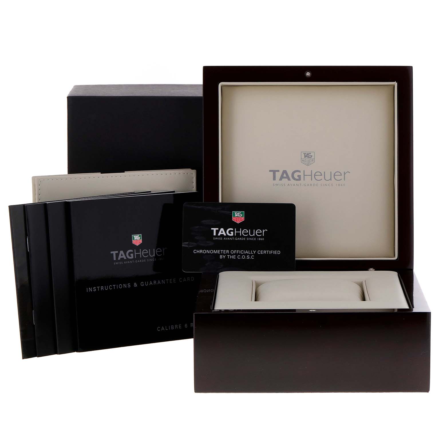 This image shows the packaging, instruction manuals, and certification cards for the Carrera model by TAG Heuer.