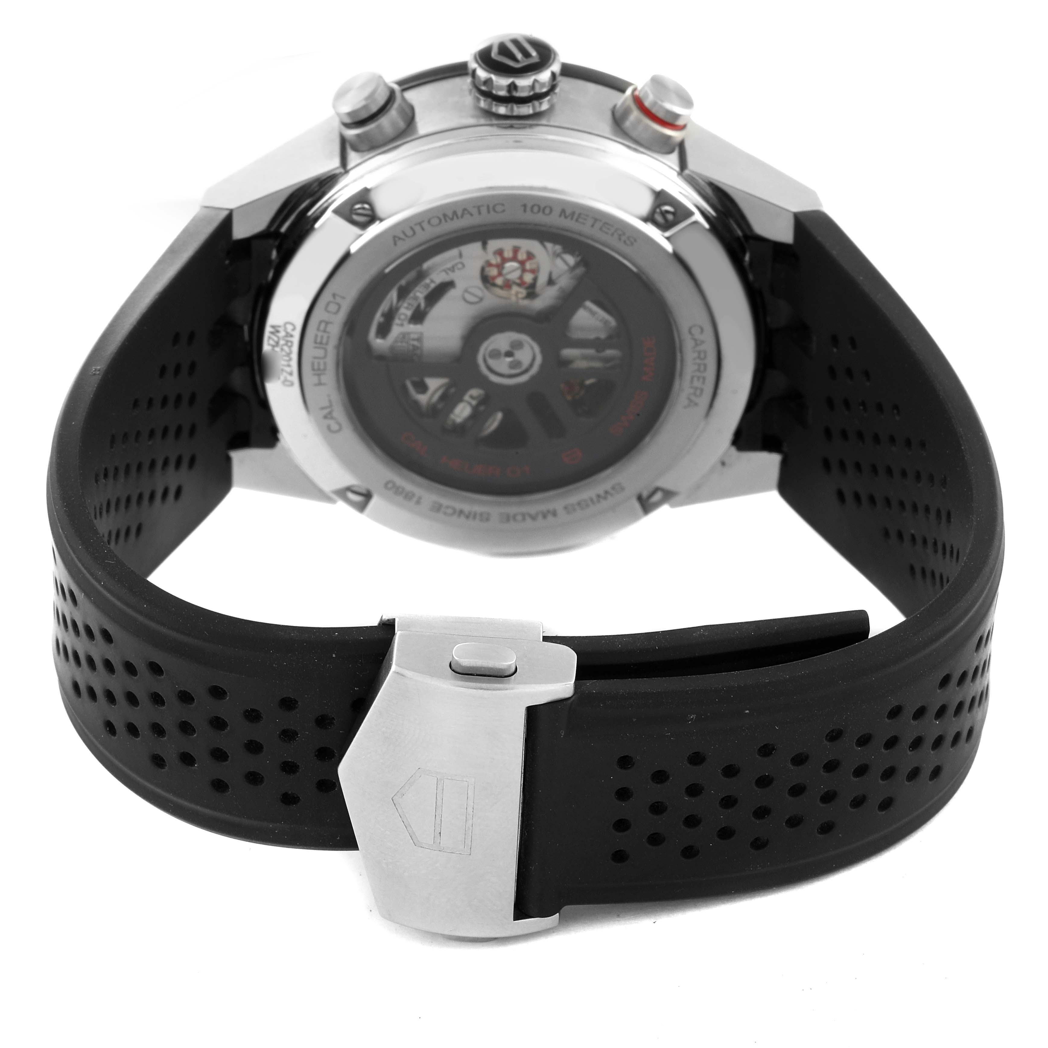 The image shows the back view of a Tag Heuer Carrera CAR201Z.BA0714 Men's Stainless Steel Black Dial CAR201Z.BA0714 Men's Stainless Steel Black Dial watch, highlighting its automatic movement and rubber strap with deployant clasp.