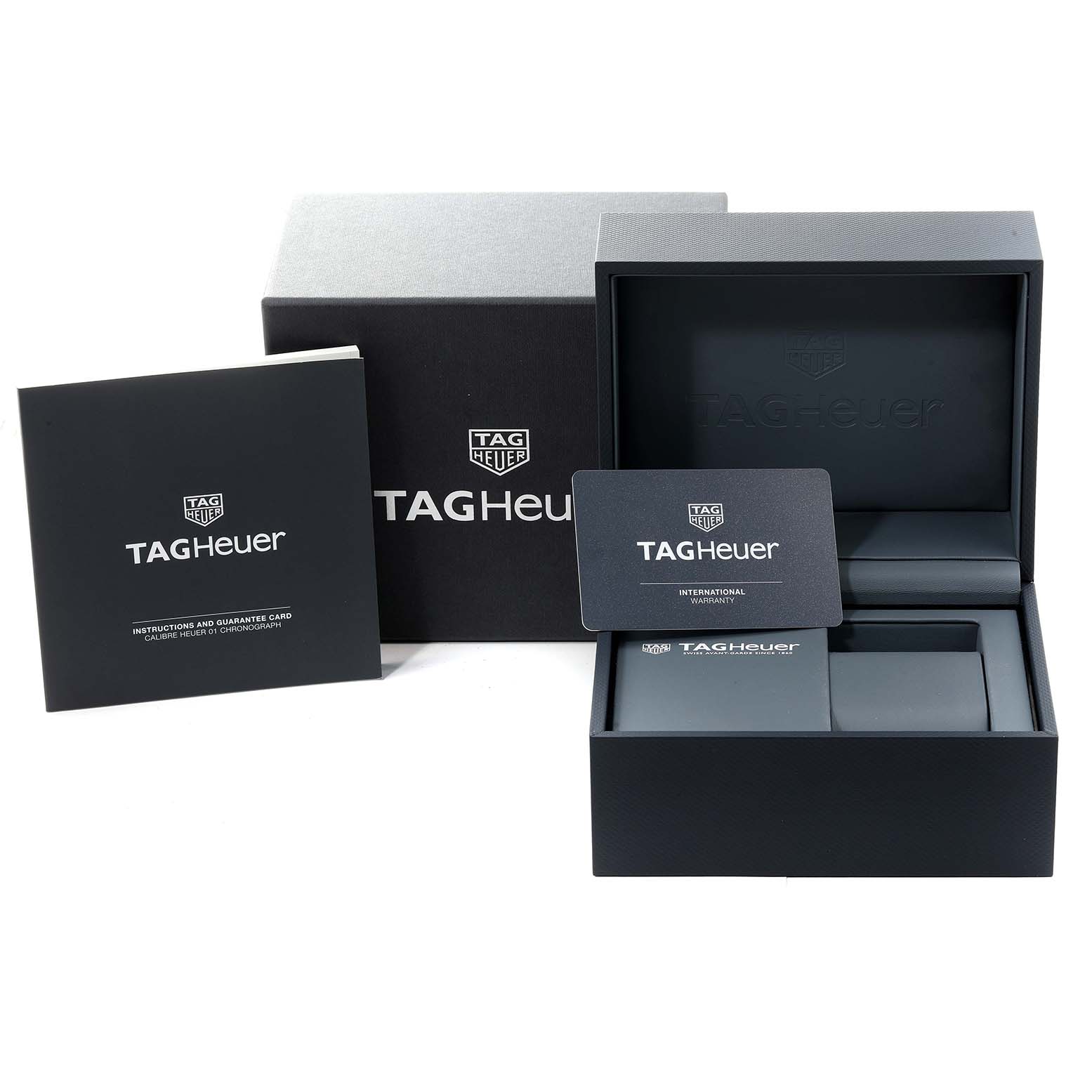 This image shows the packaging, instruction booklet, and warranty card for a Tag Heuer Carrera CAR201Z.BA0714 Men's Stainless Steel Black Dial CAR201Z.BA0714 Men's Stainless Steel Black Dial watch.