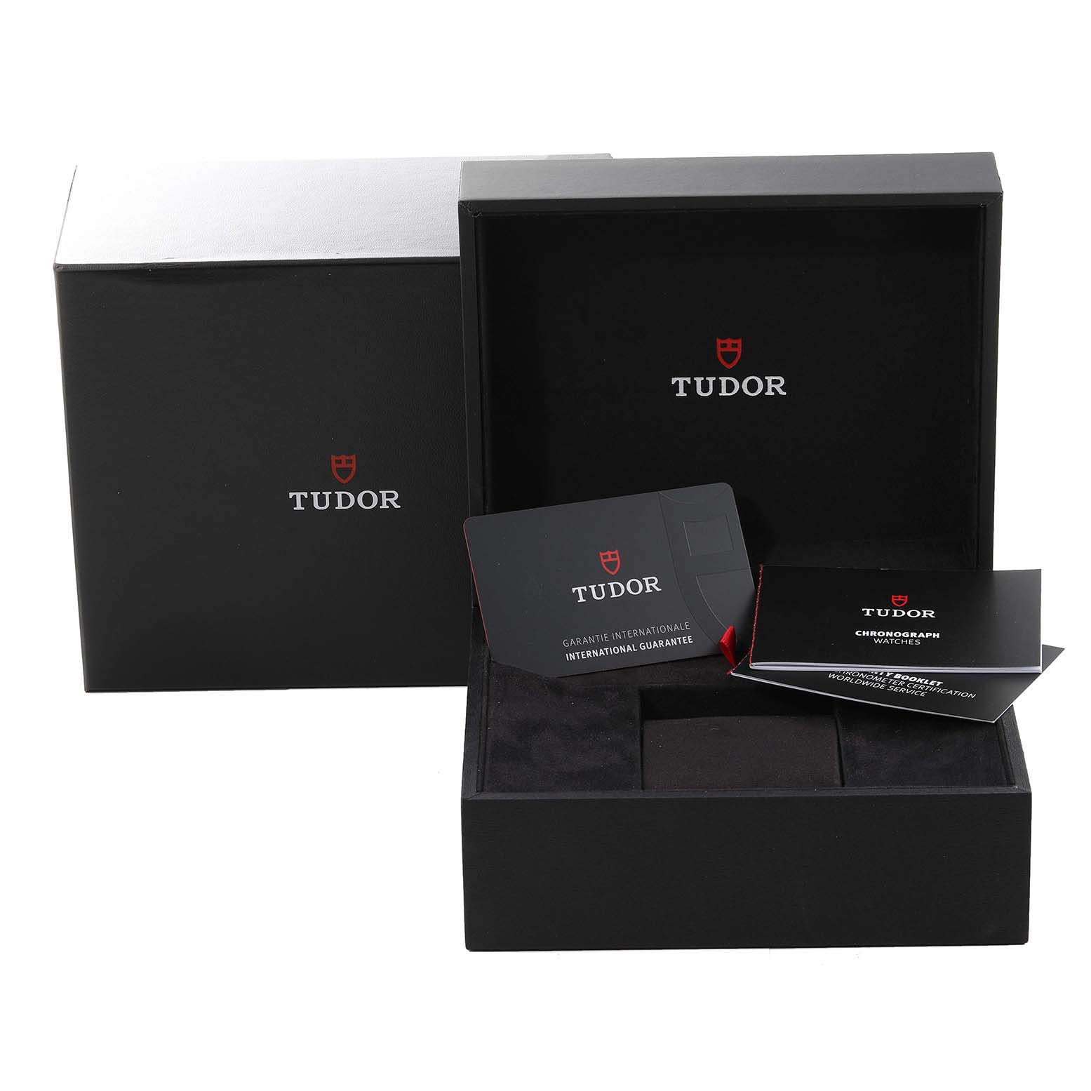 The image shows the packaging, warranty card, and instruction manuals for the Tudor Heritage Chrono 79350 Men's Stainless Steel Black Dial 79350 Men's Stainless Steel Black Dial watch, with an open box displaying these items.