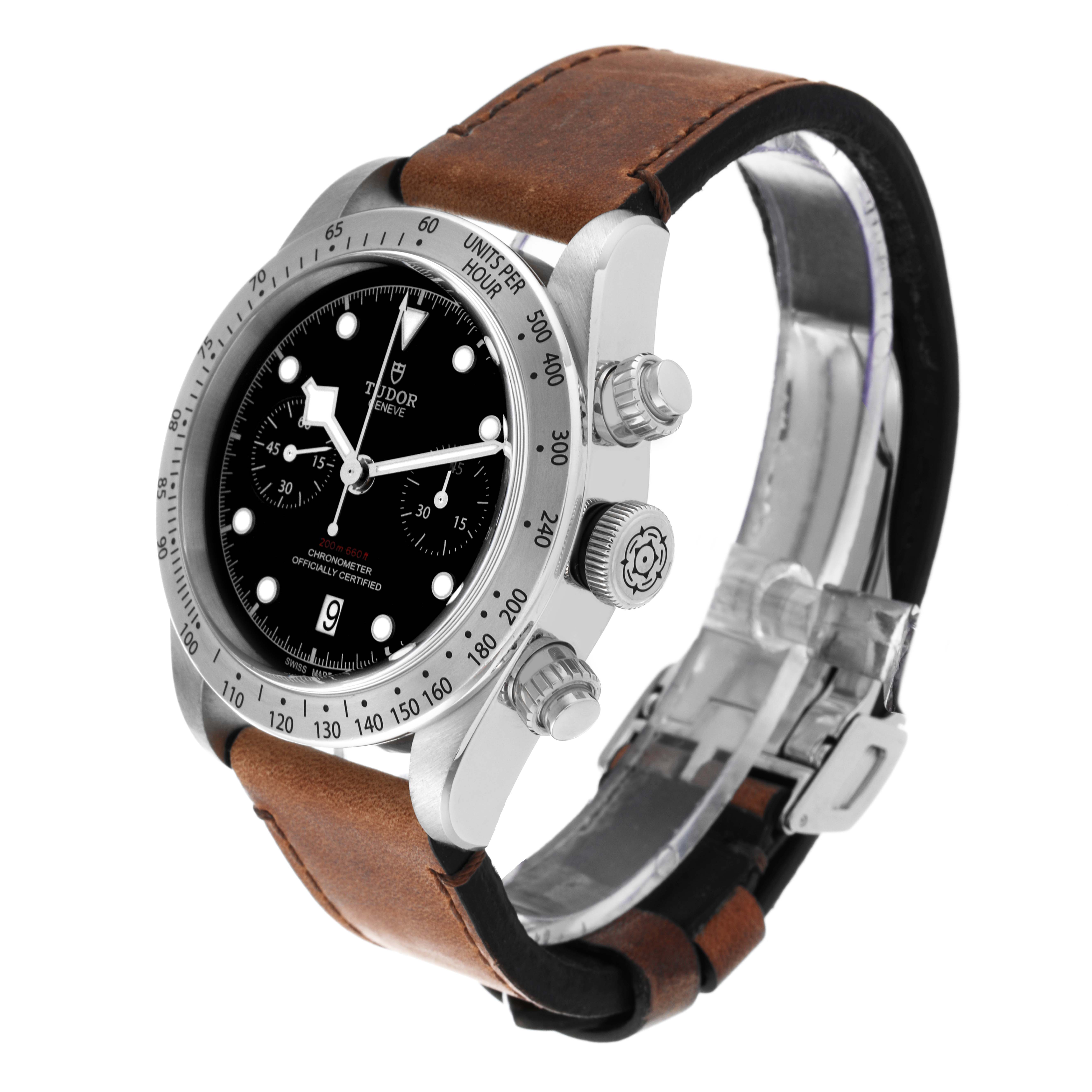 The image shows a side angle of the Tudor Heritage Chrono 79350 Men's Stainless Steel Black Dial 79350 Men's Stainless Steel Black Dial watch featuring its face, bezel, crown, pushers, and leather strap.