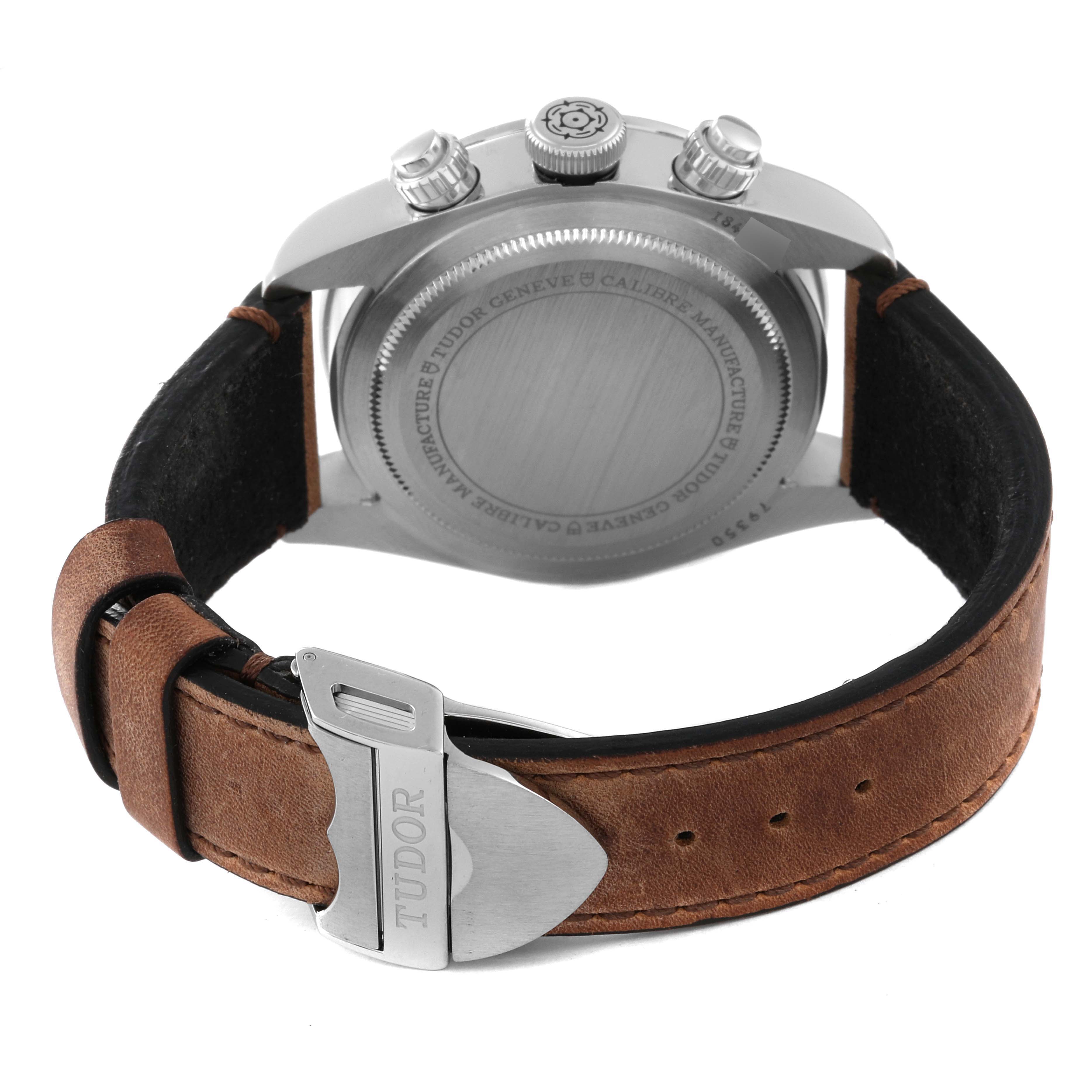 The Tudor Heritage Chrono 79350 Men's Stainless Steel Black Dial 79350 Men's Stainless Steel Black Dial watch is shown from the back, highlighting the case, case back, pushers, and leather strap with buckle.