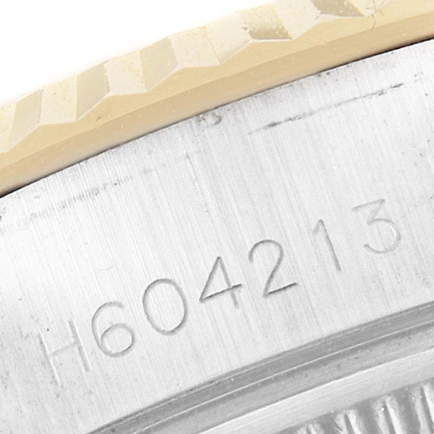 This close-up image shows the edge of the watch case and the serial number of a Tudor Princess 92413 Women's Steel and Gold (two tone) Champagne Dial 92413 Women's Steel and Gold (two tone) Champagne Dial model watch.