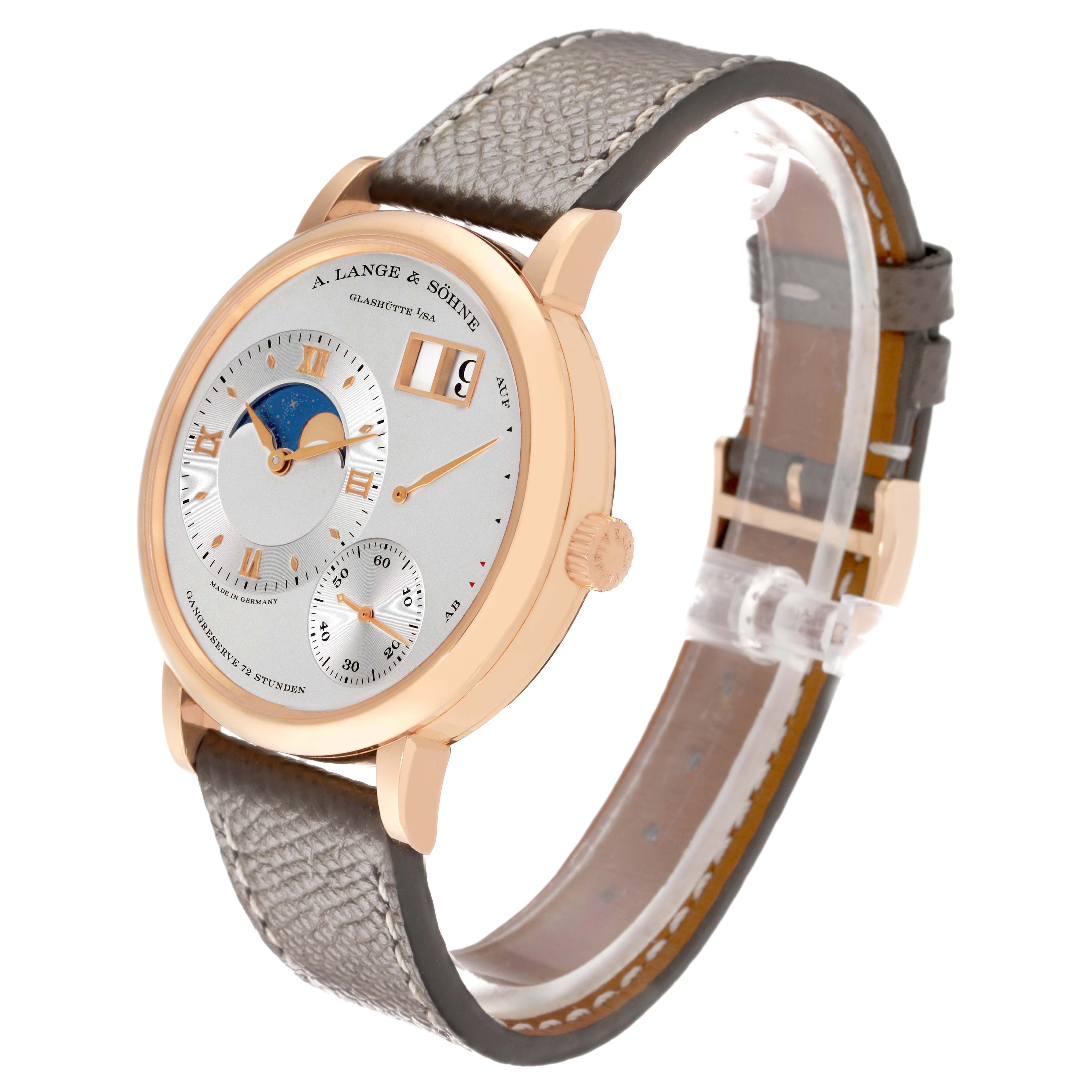 The A. Lange & Sohne Lange 1 139.032 Men's Rose Gold Silver Dial watch is shown at a 3/4 angle displaying its face, side, and textured strap.