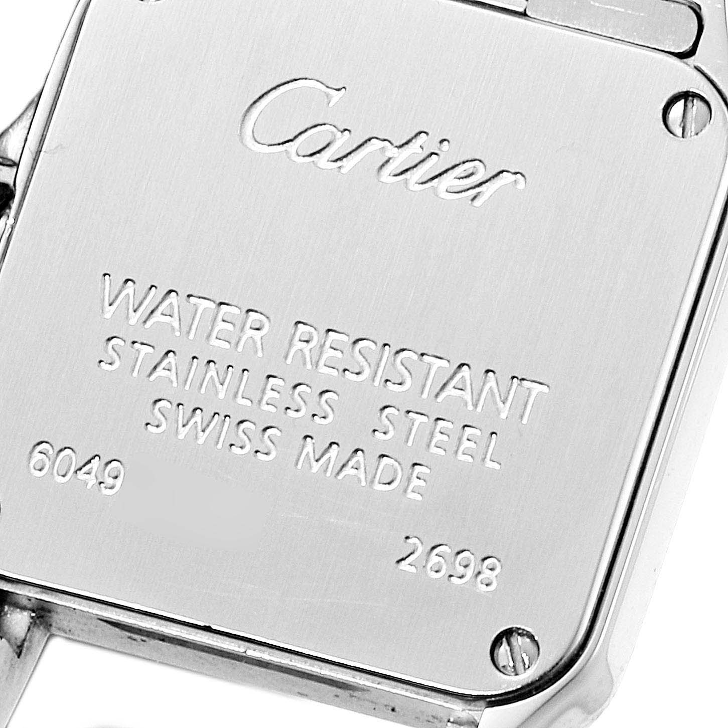 The image shows the back casing of a Cartier Santos Demoiselle W25064Z5 Women
s Stainless Steel Silver Dial W25064Z5 Women
s Stainless Steel Silver Dial watch, highlighting the engraved details.