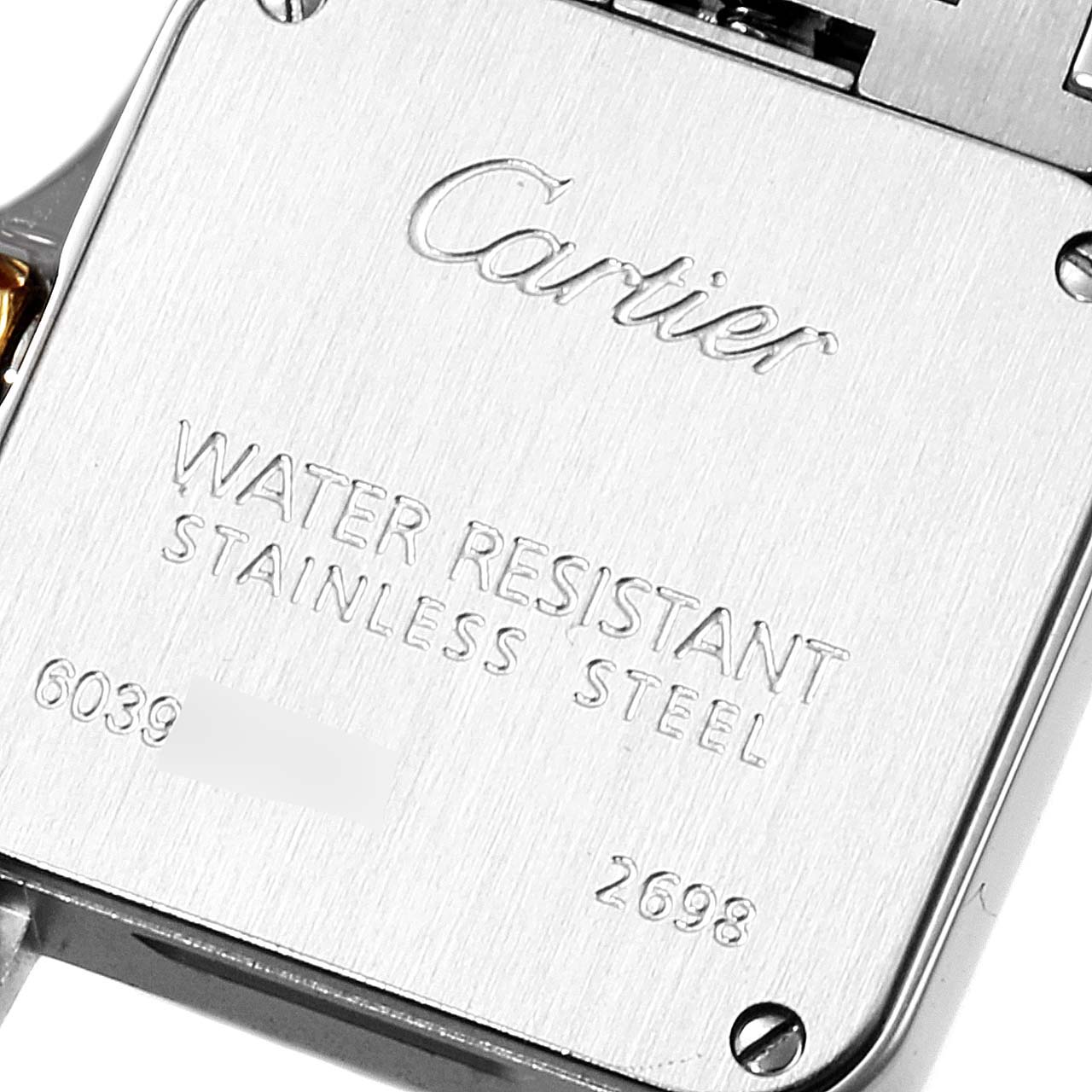 This is a close-up of the back of a Cartier Santos Demoiselle W25066Z6 Women
s Steel and Gold (two tone) Silver Dial W25066Z6 Women
s Steel and Gold (two tone) Silver Dial watch, showing the brand name, water resistance, and stainless steel details.