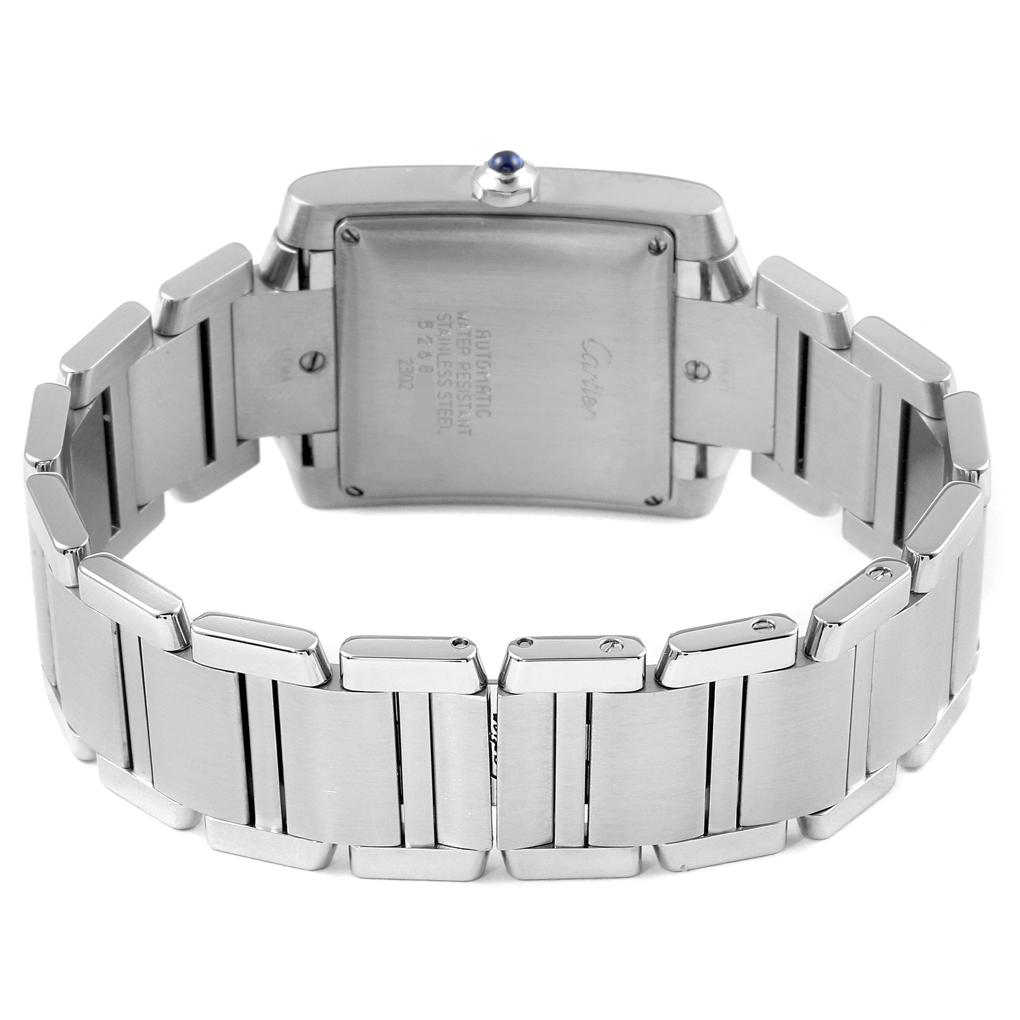 The image shows the back view of the Cartier Tank Française watch, highlighting the stainless steel bracelet and case back.