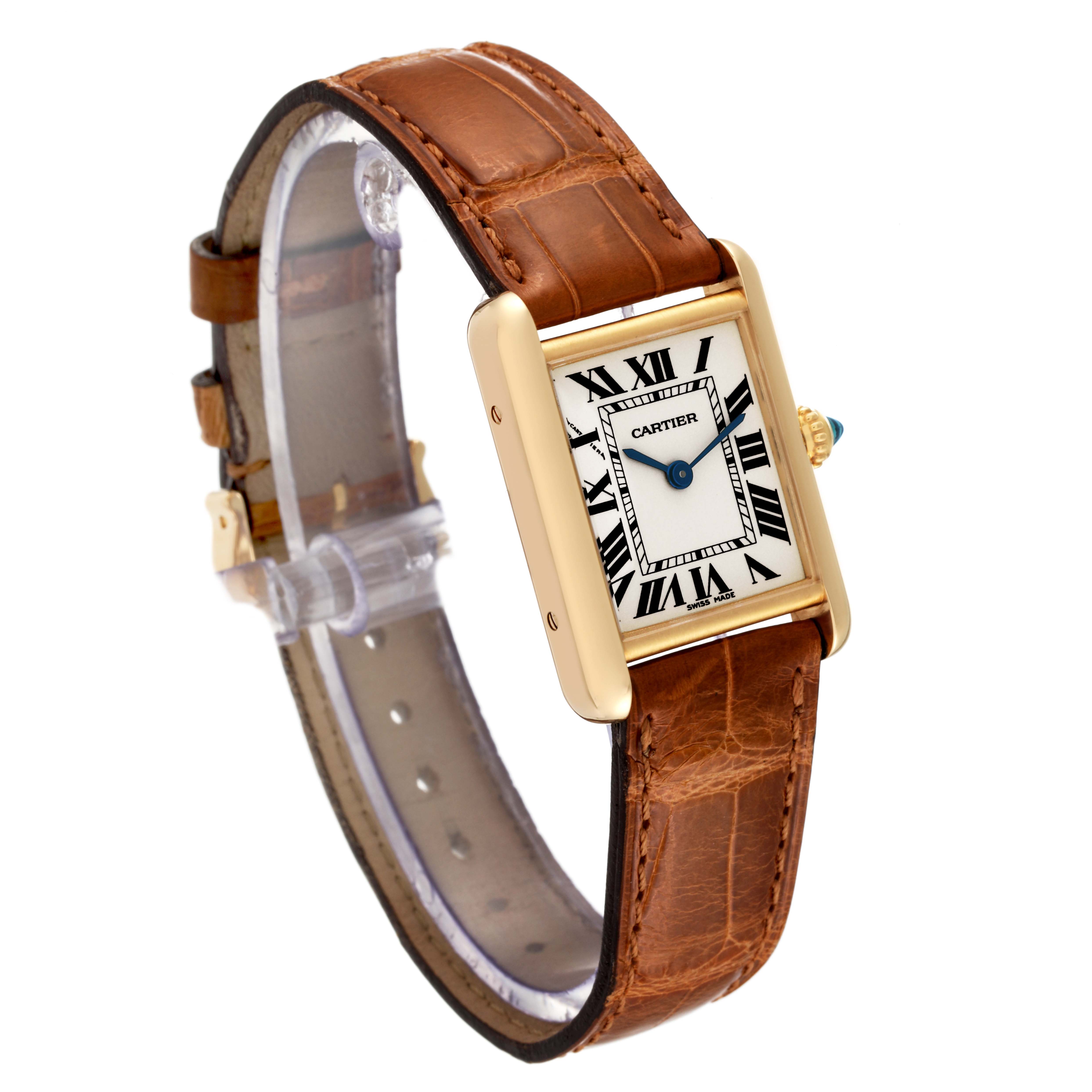 The image shows a Tank Louis watch by Cartier at an angle, highlighting its rectangular face and brown leather strap.