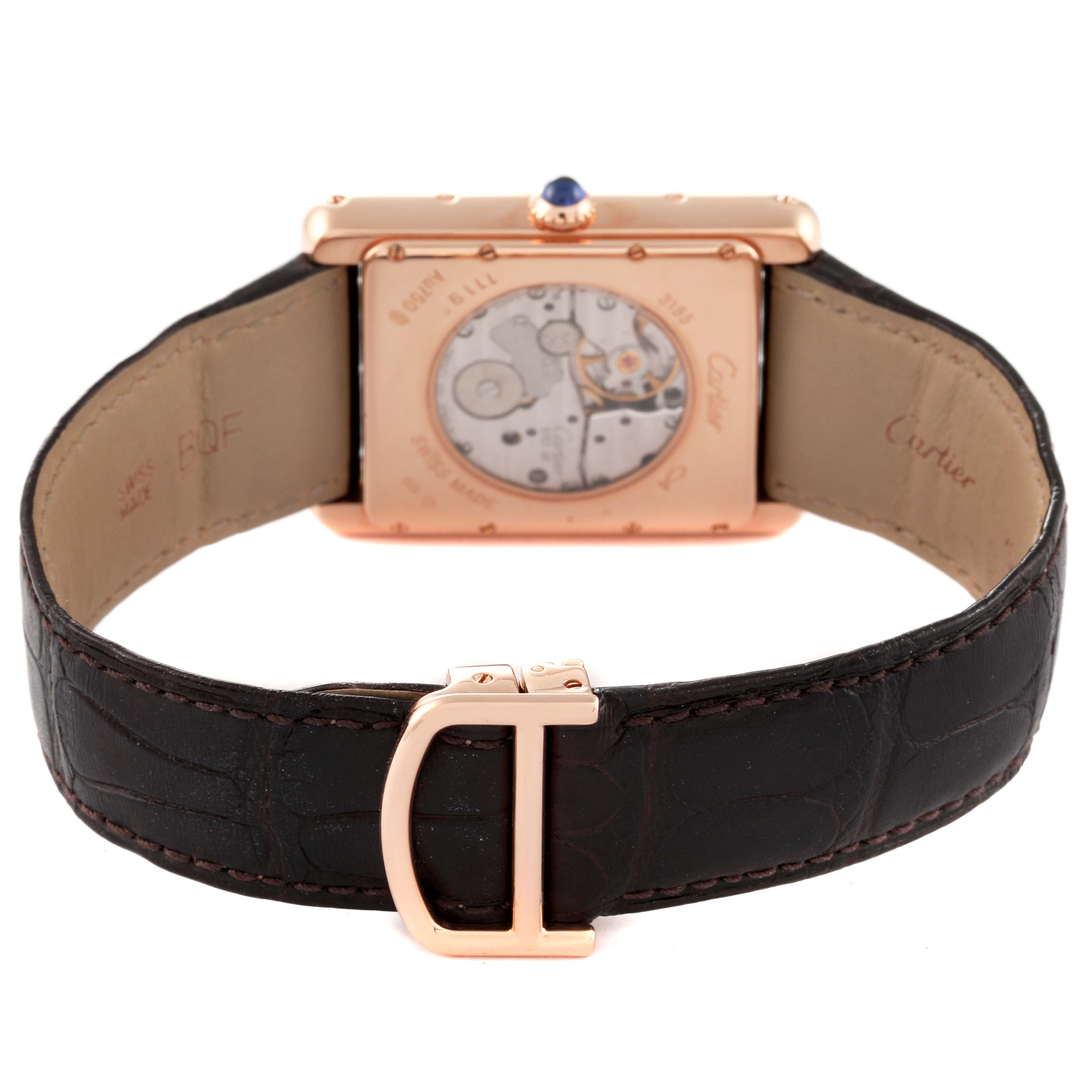 The image shows the back view of a Cartier Tank Louis W1560003 Men's Rose Gold Silver Dial W1560003 Men's Rose Gold Silver Dial watch, highlighting its mechanism and leather strap with a gold clasp.