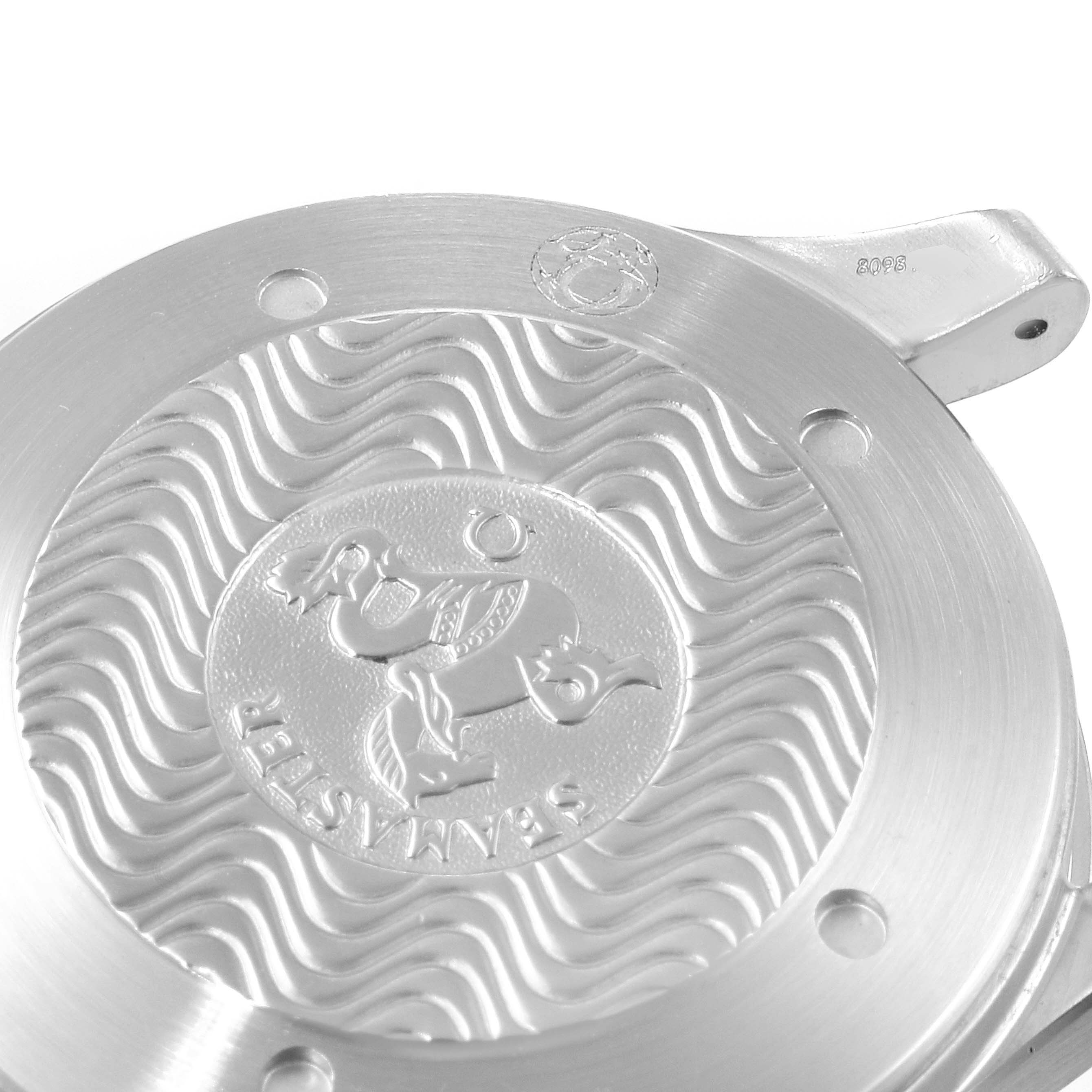 The image shows a detailed view of the case back of an Omega Seamaster 2538.20.00 Men's Stainless Steel White Dial 2538.20.00 Men's Stainless Steel White Dial watch, highlighting the engraved emblem and wave pattern.