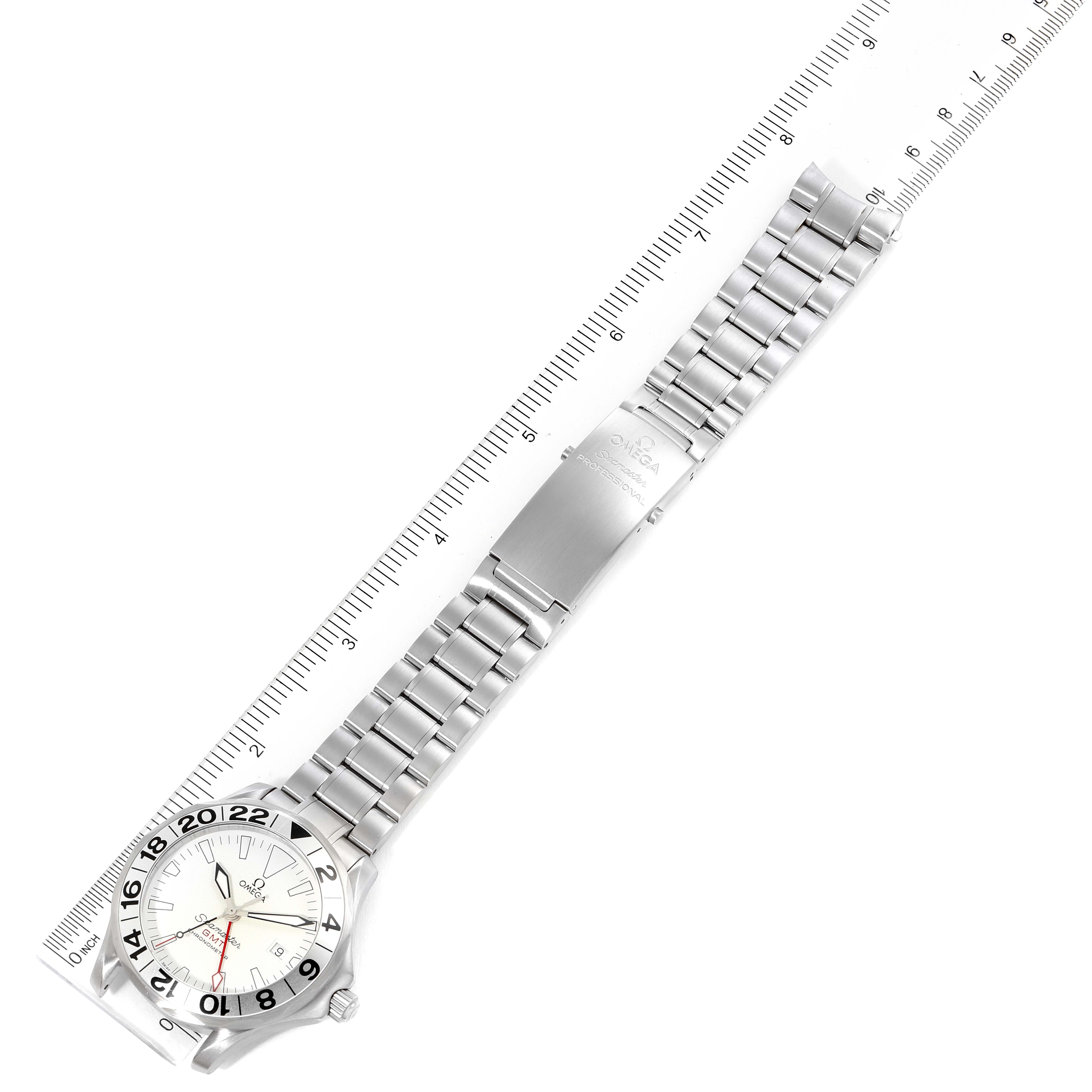 The image shows an Omega Seamaster 2538.20.00 Men's Stainless Steel White Dial 2538.20.00 Men's Stainless Steel White Dial watch laid flat with its metal bracelet extended alongside a ruler for scale.