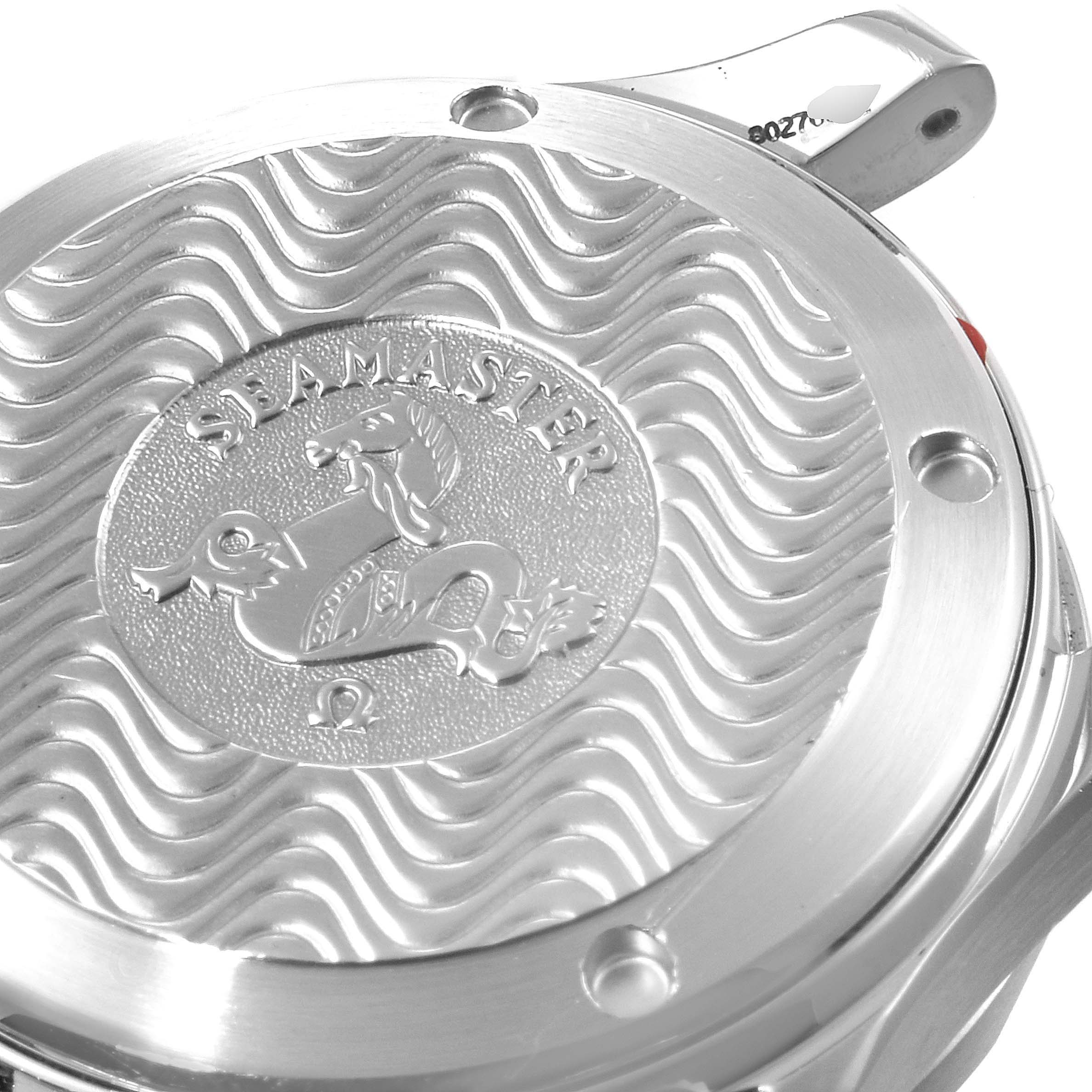 The image shows the backside of an Omega Seamaster 2236.50.00 Men
s Stainless Steel Black Dial 2236.50.00 Men
s Stainless Steel Black Dial watch with its distinct wave pattern and engraved logo.