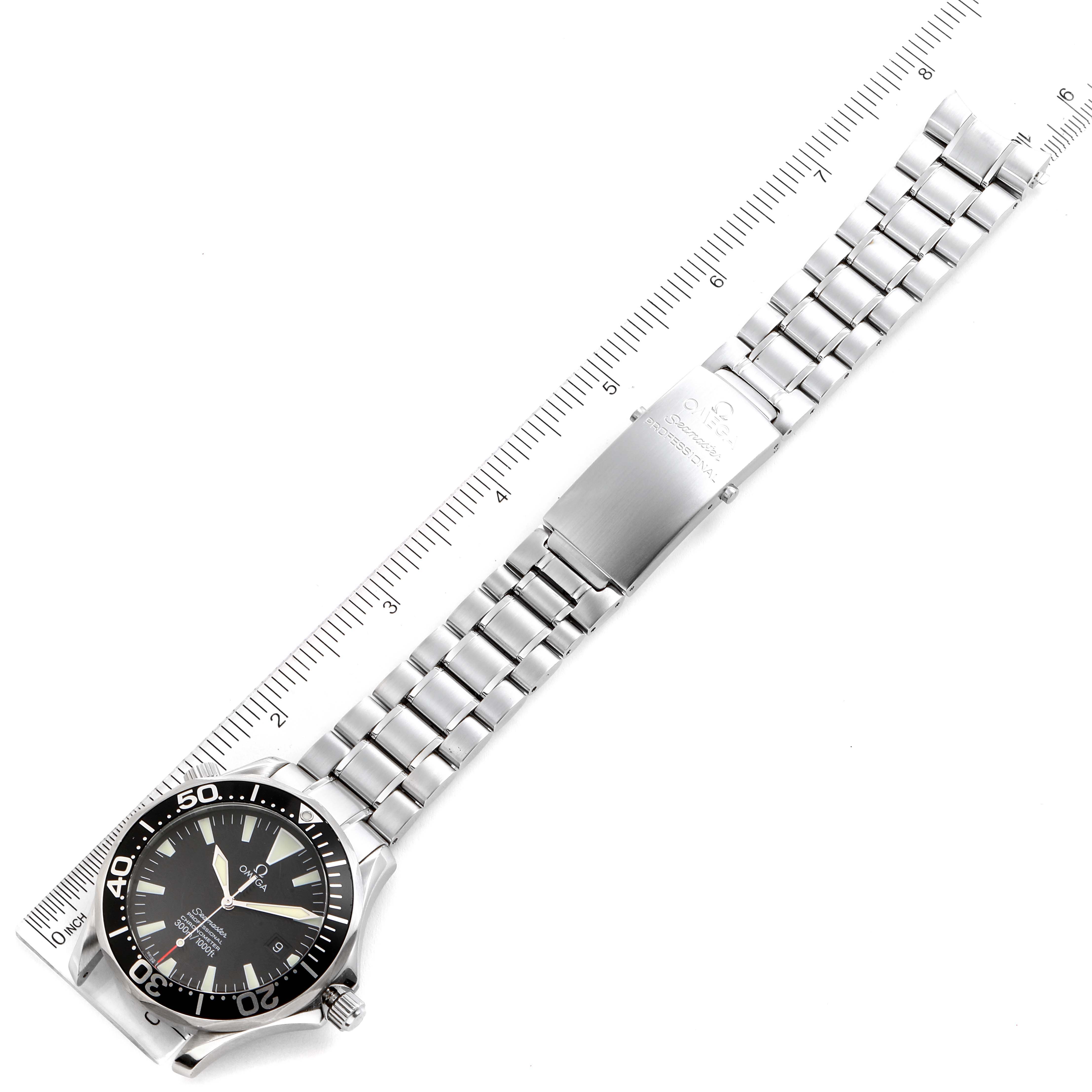 The Omega Seamaster 2254.50.00 Men
s Stainless Steel Black Dial 2254.50.00 Men
s Stainless Steel Black Dial watch is shown from a top-down angle, displaying the face and entire metal bracelet with a ruler for scale.