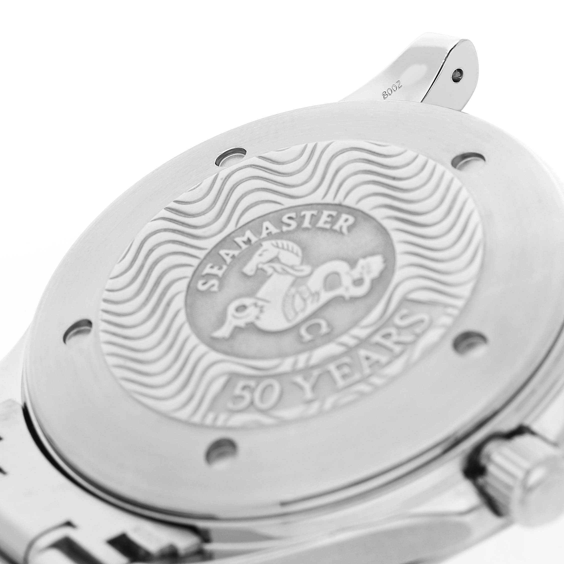 The image shows the case back of an Omega Seamaster 2234.50.00 Men's Stainless Steel Black Dial watch, featuring engraved waves and "50 Years."