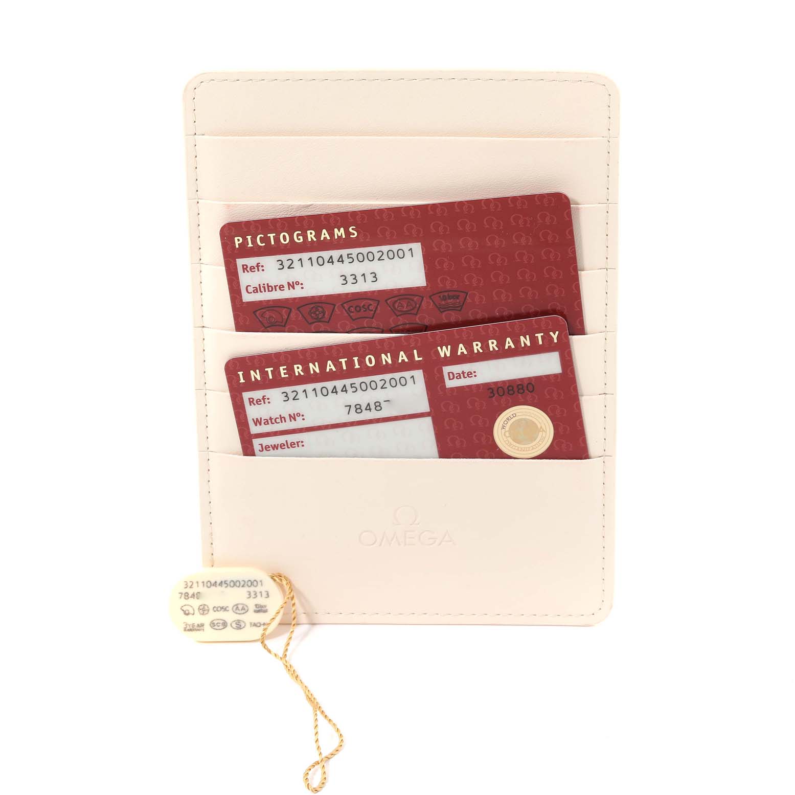 The image shows warranty cards and a tag for the Omega Speedmaster 321.10.44.50.02.001 Men's Stainless Steel Silver Dial 321.10.44.50.02.001 Men's Stainless Steel Silver Dial in a white cardholder, viewed from above.