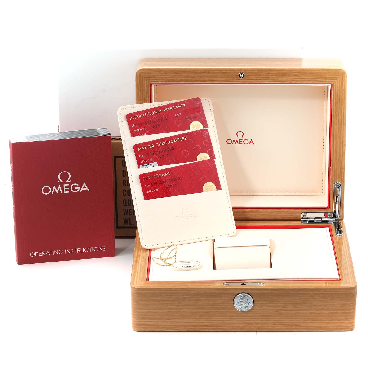 The image shows an Omega Speedmaster 329.33.44.51.04.001 Men's Stainless Steel Silver Dial 329.33.44.51.04.001 Men's Stainless Steel Silver Dial watch box, warranty cards, and an operating instructions manual displayed at an angle.