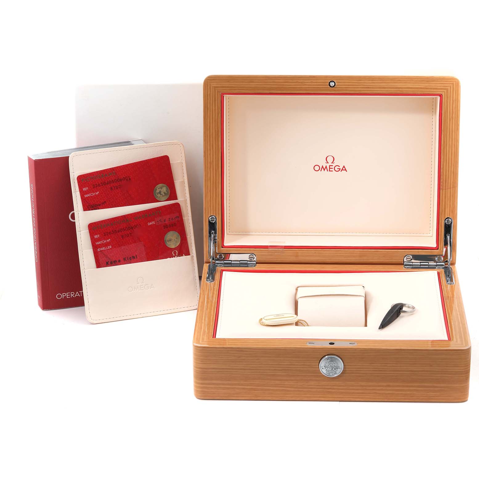 This image shows an Omega Speedmaster 326.30.40.50.06.001 Men's Stainless Steel Grey Dial 326.30.40.50.06.001 Men's Stainless Steel Grey Dial watch box, warranty cards, and a booklet, viewed from the front at a slight angle.