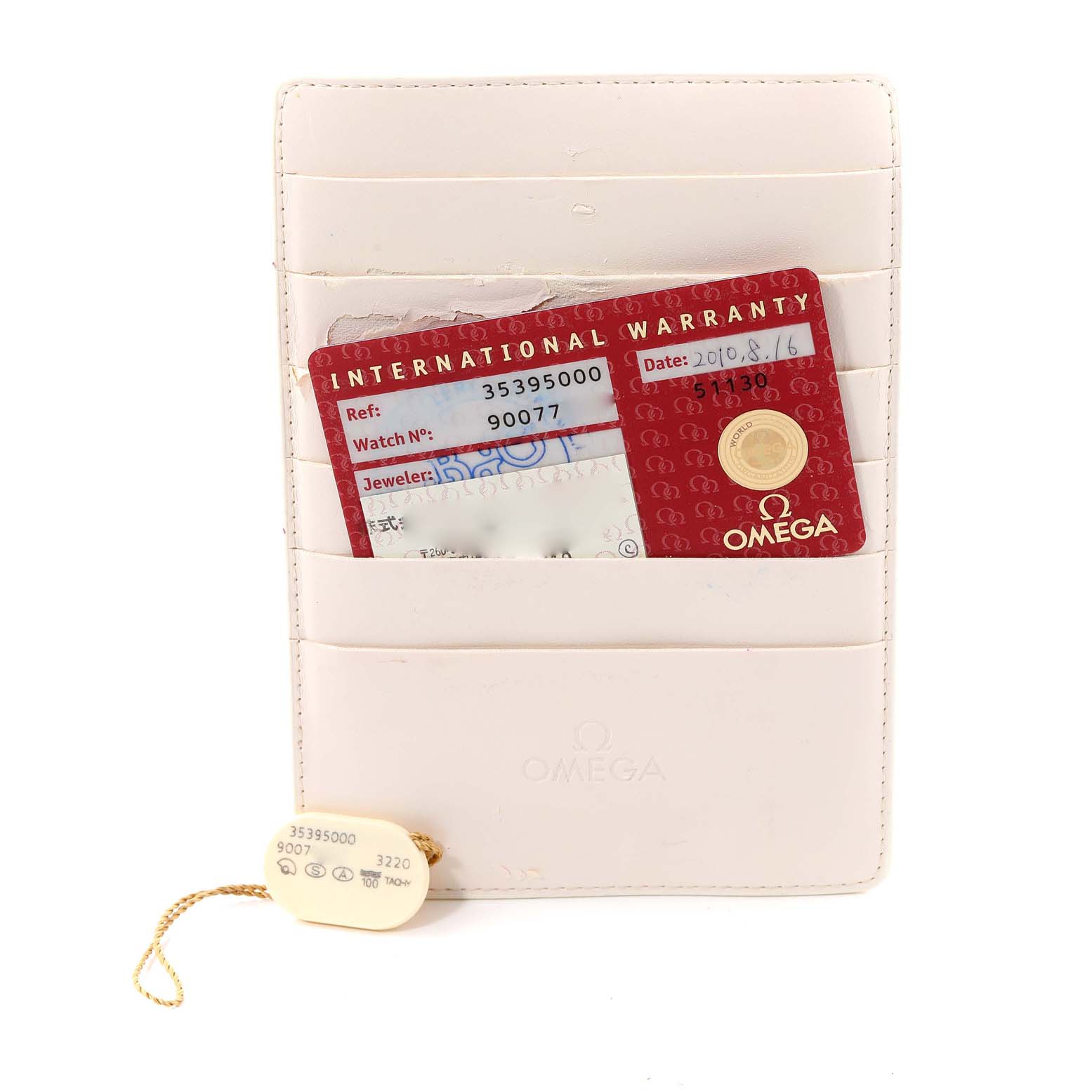 This image shows the warranty card and tags for an Omega Speedmaster 3539.50.00 Men's Stainless Steel Black Dial 3539.50.00 Men's Stainless Steel Black Dial watch.