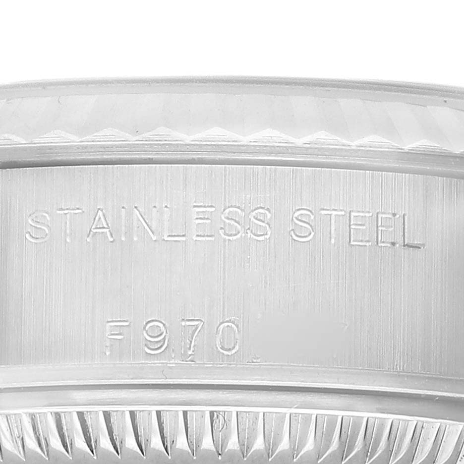 The image shows an angled close-up of the stainless steel case's side of the Patek Philippe Twenty-4 7300/1200A-011 Women's Stainless Steel Green Dial watch, highlighting engraved details.