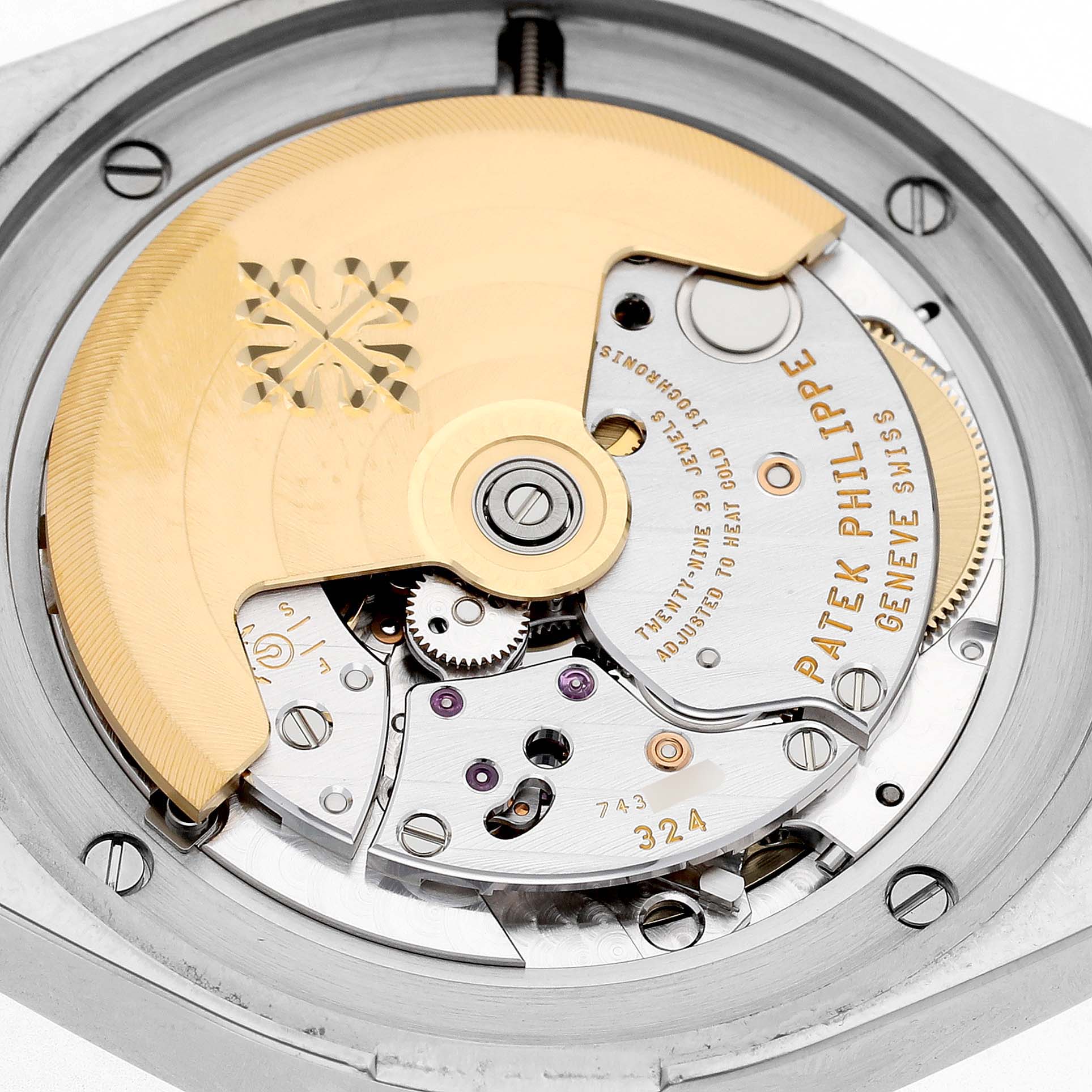 The image shows a close-up of the movement inside a Patek Philippe Twenty-4 7300/1200A-011 Women's Stainless Steel Green Dial watch, highlighting the rotor and intricate gears.