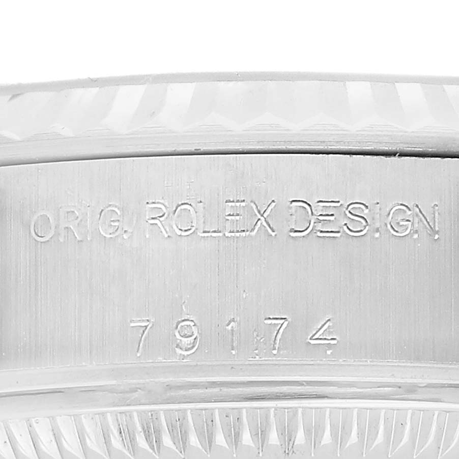 This image shows the side of a watch bezel with engravings, unrelated to the Patek Philippe Twenty-4 7300/1200A-011 Women's Stainless Steel Green Dial model.