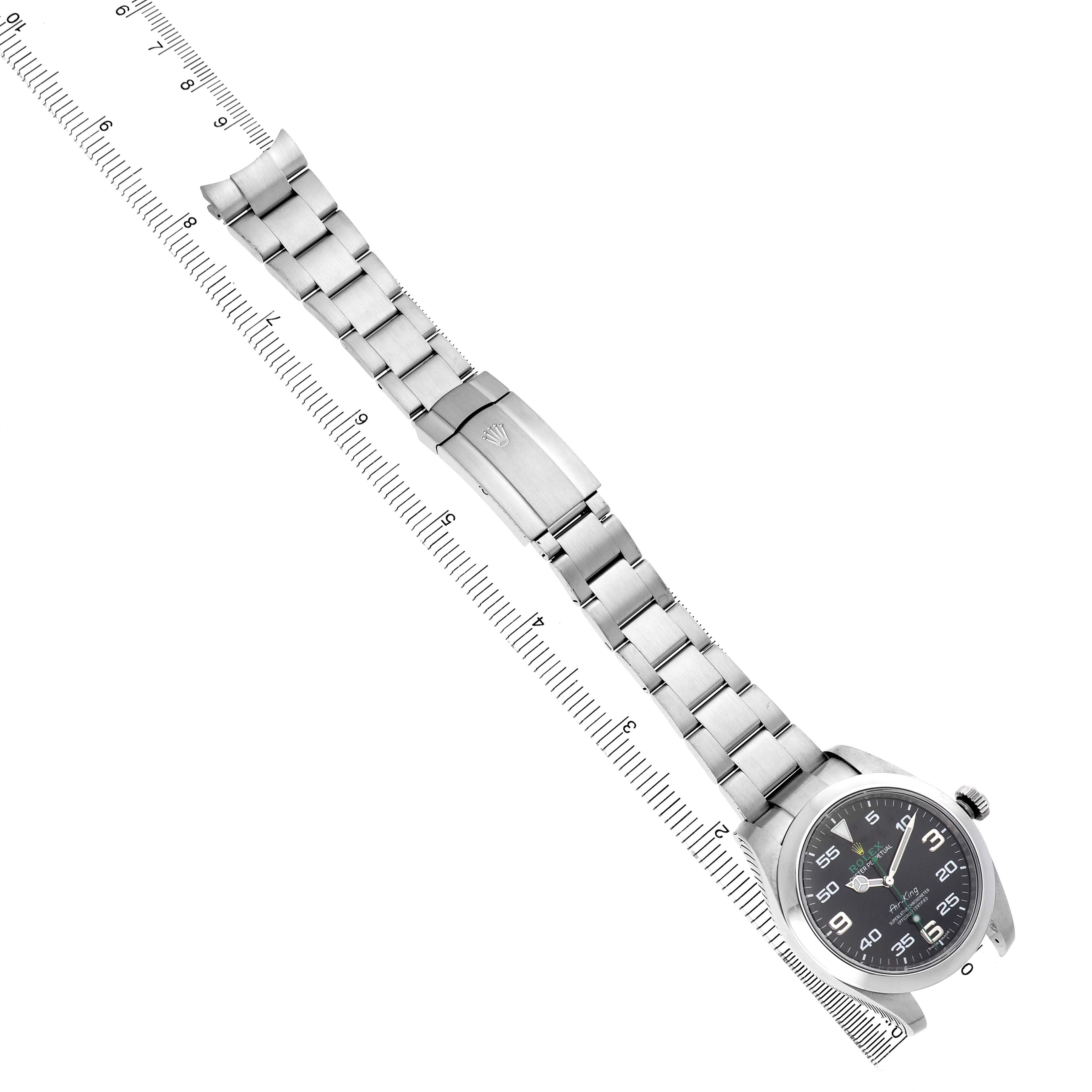 The Rolex Air-King 116900 Men's Stainless Steel Black Dial watch is shown from an angled top view, displaying its entire bracelet and clasp.