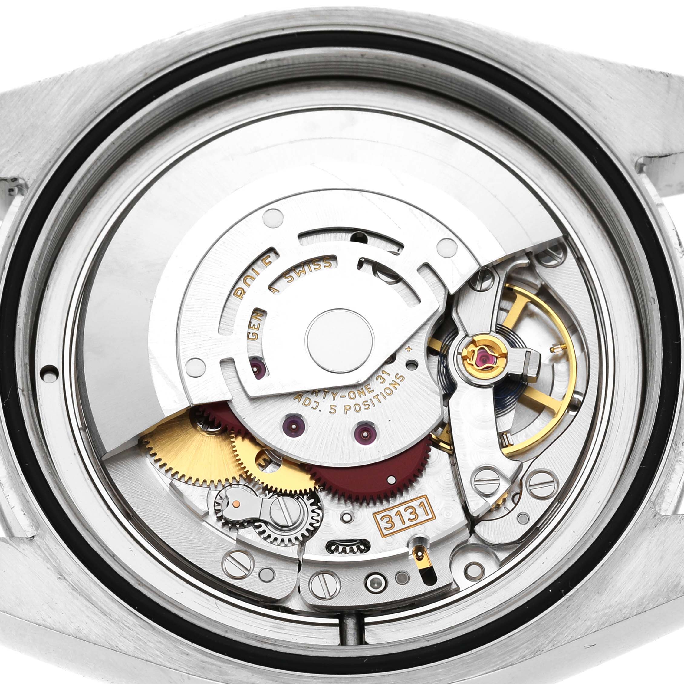 The image shows the movement of a Rolex Air-King 116900 Men's Stainless Steel Black Dial watch from the back, highlighting its intricate components and mechanics.
