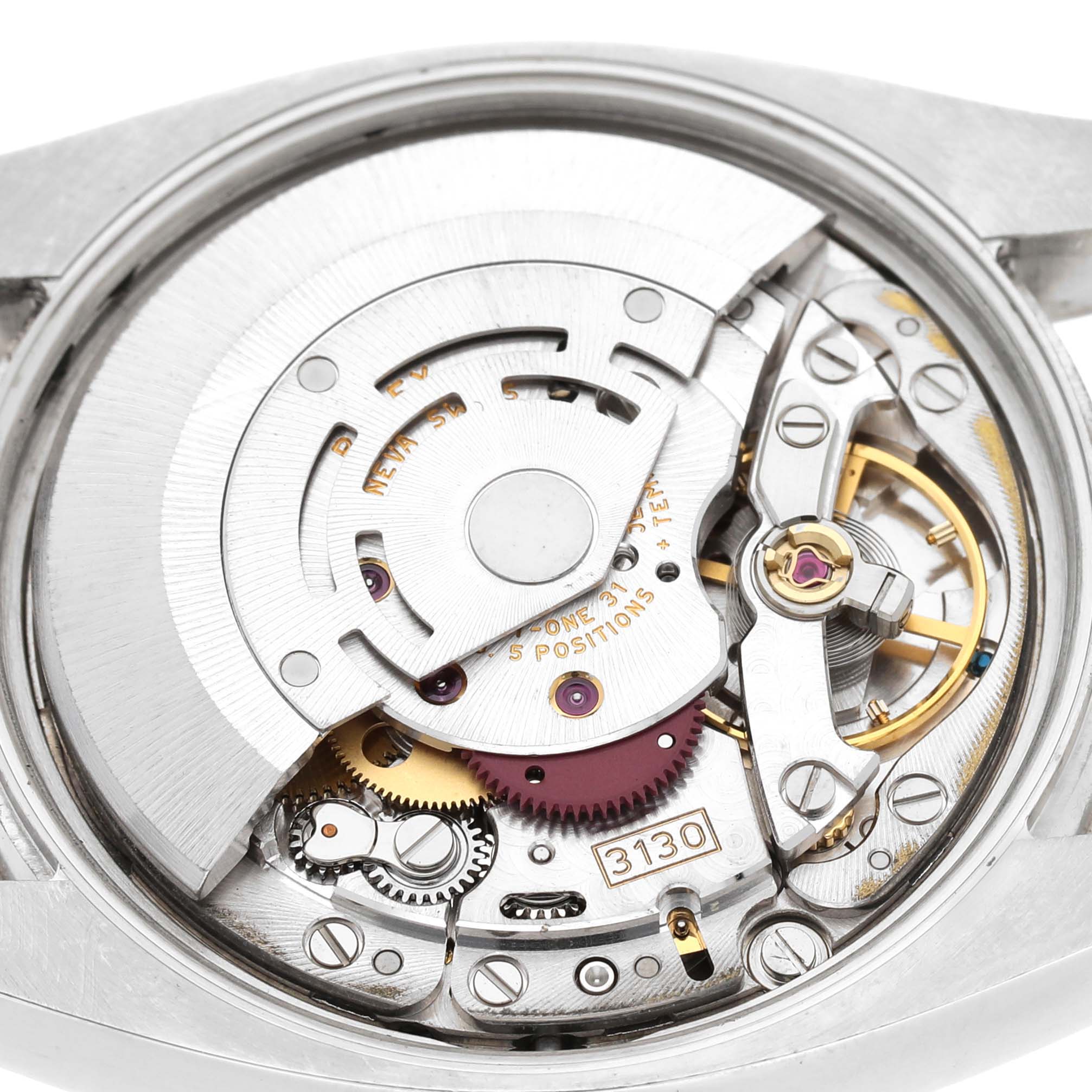 The image shows the movement of a Rolex Air-King 114234 Men's Stainless Steel Blue Dial watch from a top-down angle, highlighting its intricate mechanics.