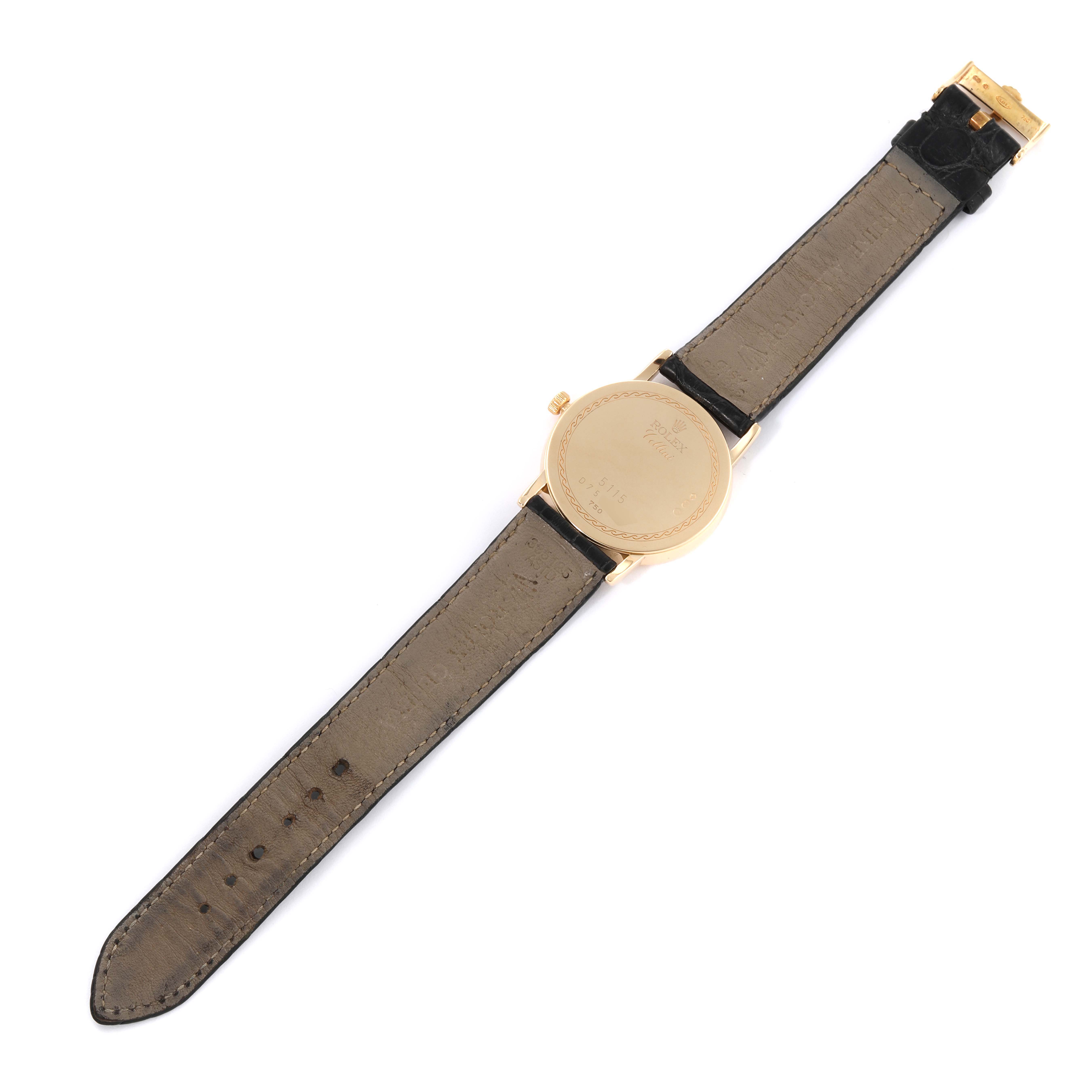 The image shows the back side of the Rolex Cellini 5115 Men's Yellow Gold Beige Dial 5115 Men's Yellow Gold Beige Dial watch including its strap and clasp, laid flat.