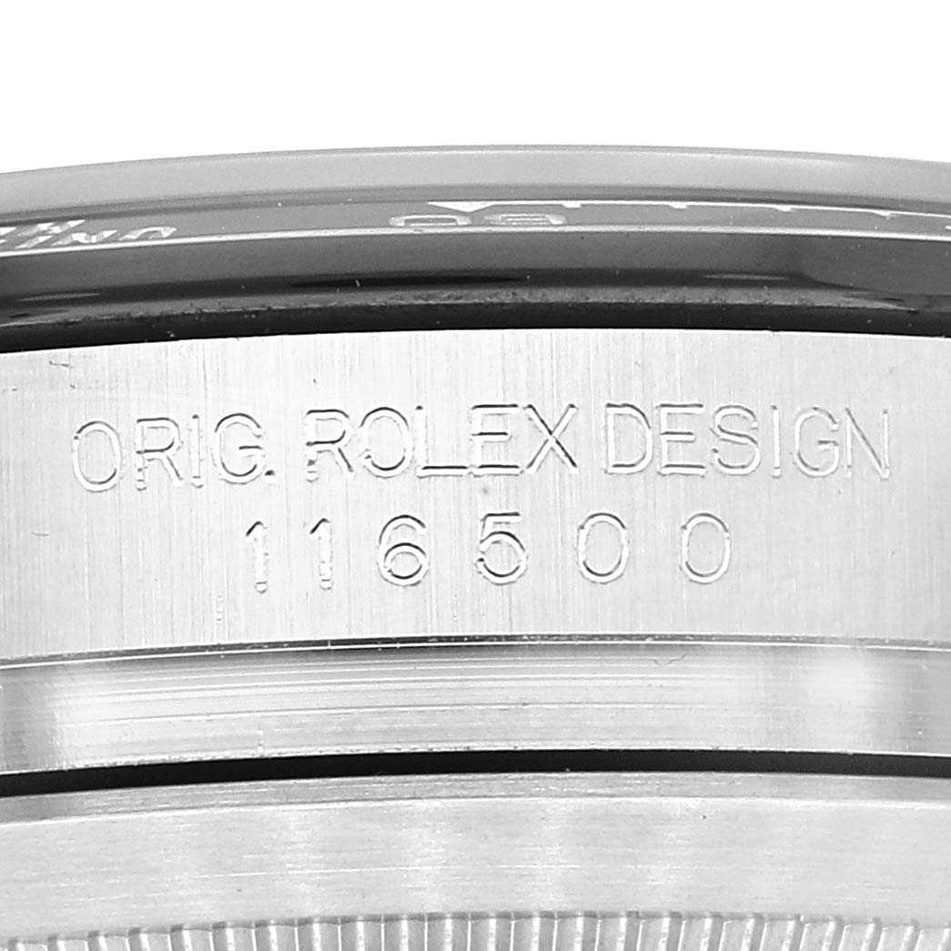 The image shows a close-up of the side of a Rolex Daytona 116500 Men
s Stainless Steel Black Dial 116500 Men
s Stainless Steel Black Dial watch, focusing on the engraved design and model number 116500.