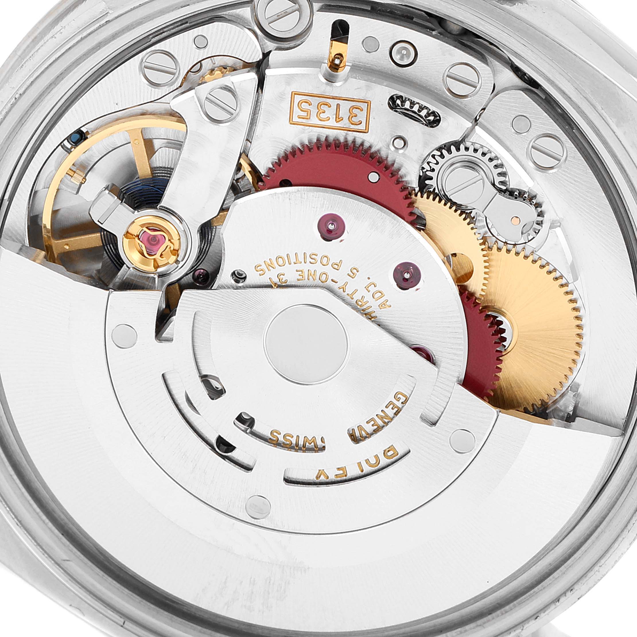 This image shows an internal view of the Rolex Datejust 115234 Men's Stainless Steel Silver Dial 115234 Men's Stainless Steel Silver Dial watch, highlighting its intricate mechanical movement and gears.