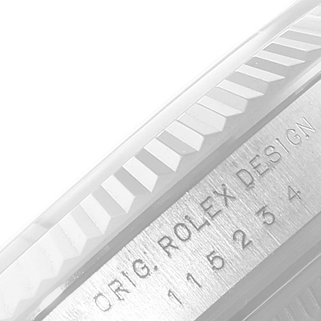 The image shows a close-up of the fluted bezel and engraved case of a Rolex Datejust 115234 Men's Stainless Steel Silver Dial 115234 Men's Stainless Steel Silver Dial watch.