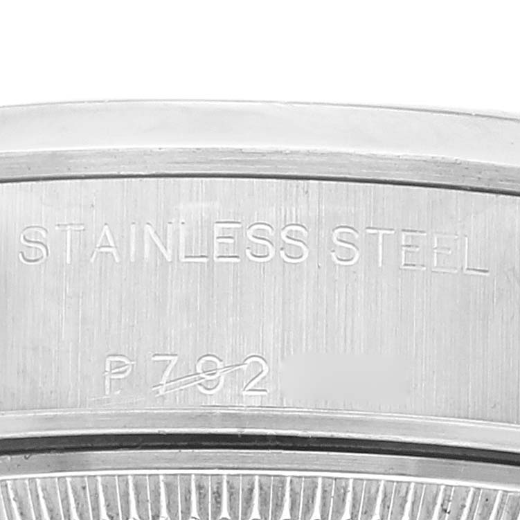 Close-up of the case back and rim of a Rolex Date 79160 Women's Stainless Steel Silver Dial 79160 Women's Stainless Steel Silver Dial model, showing the "STAINLESS STEEL" engraving and part of the serial number.