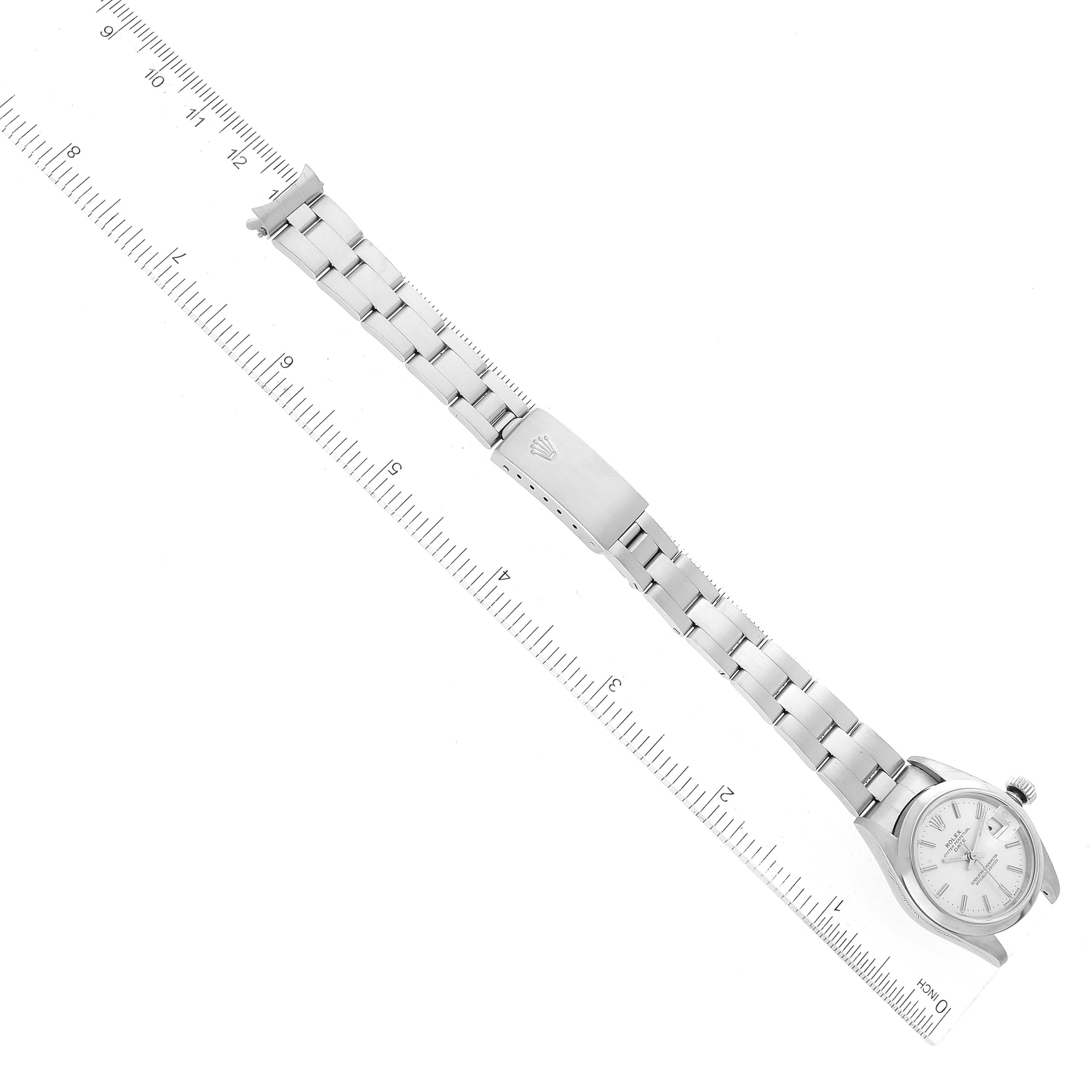 The image shows a Rolex Date 79160 Women's Stainless Steel Silver Dial 79160 Women's Stainless Steel Silver Dial model watch laid flat with its face and entire bracelet visible, alongside a ruler for scale.