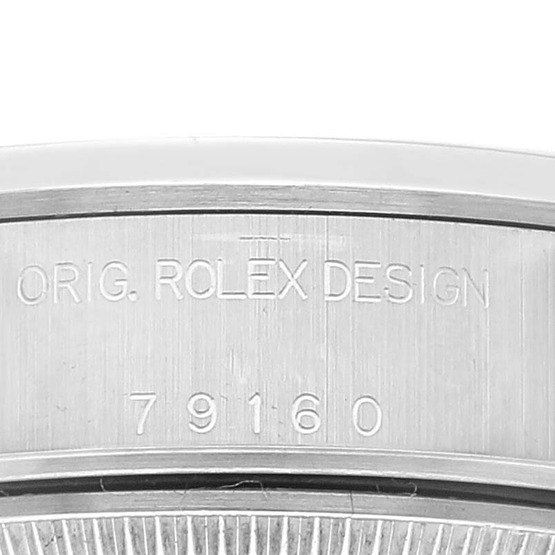 This image shows a close-up view of the case back edge with engraved text on the Rolex Date 79160 Women's Stainless Steel Silver Dial 79160 Women's Stainless Steel Silver Dial model watch.