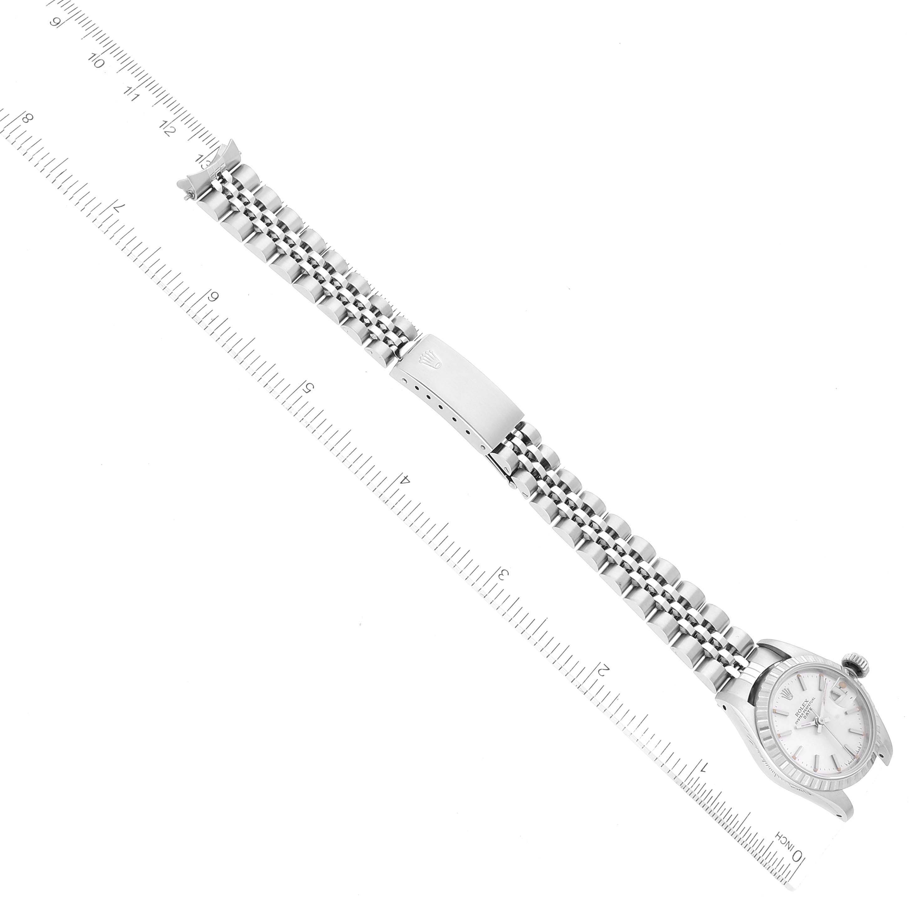 The image shows a Rolex Date 69240 Women's Stainless Steel Silver Dial 69240 Women's Stainless Steel Silver Dial model watch from a top-down angle, displaying the full watch band and face alongside a ruler for scale.